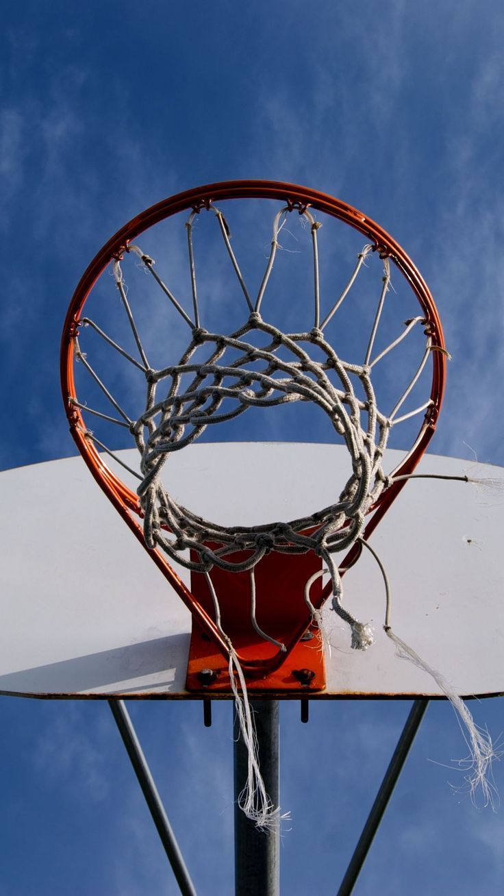 Basketball hoop with a blue sky in the background - Basketball