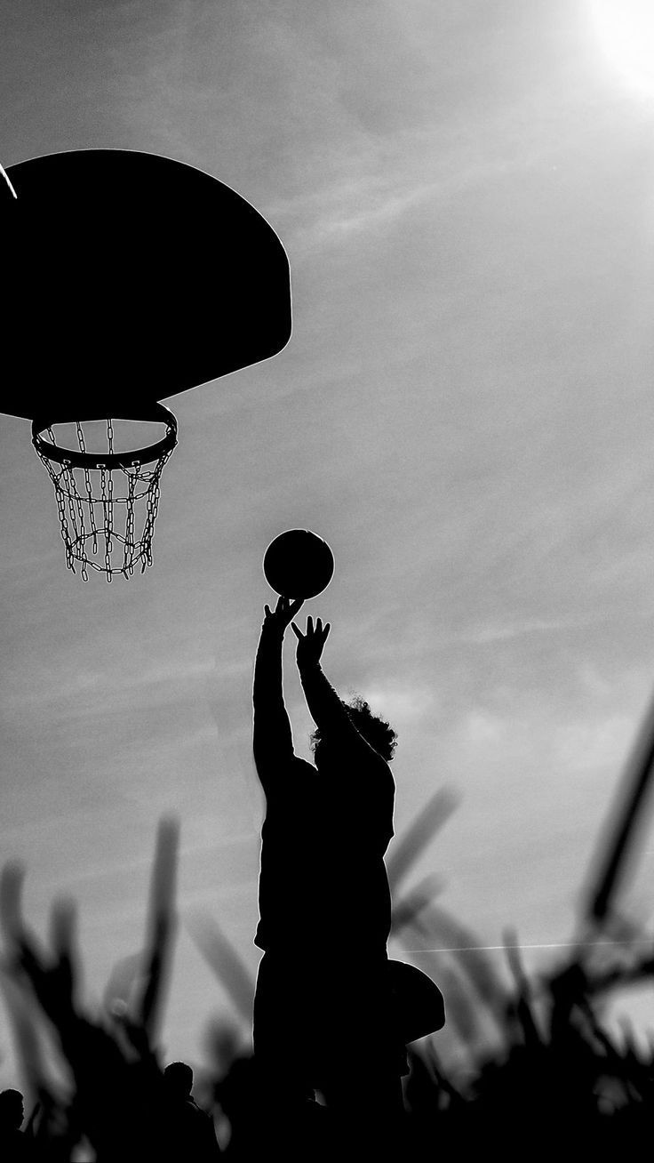 A man is jumping up to grab the ball - Basketball