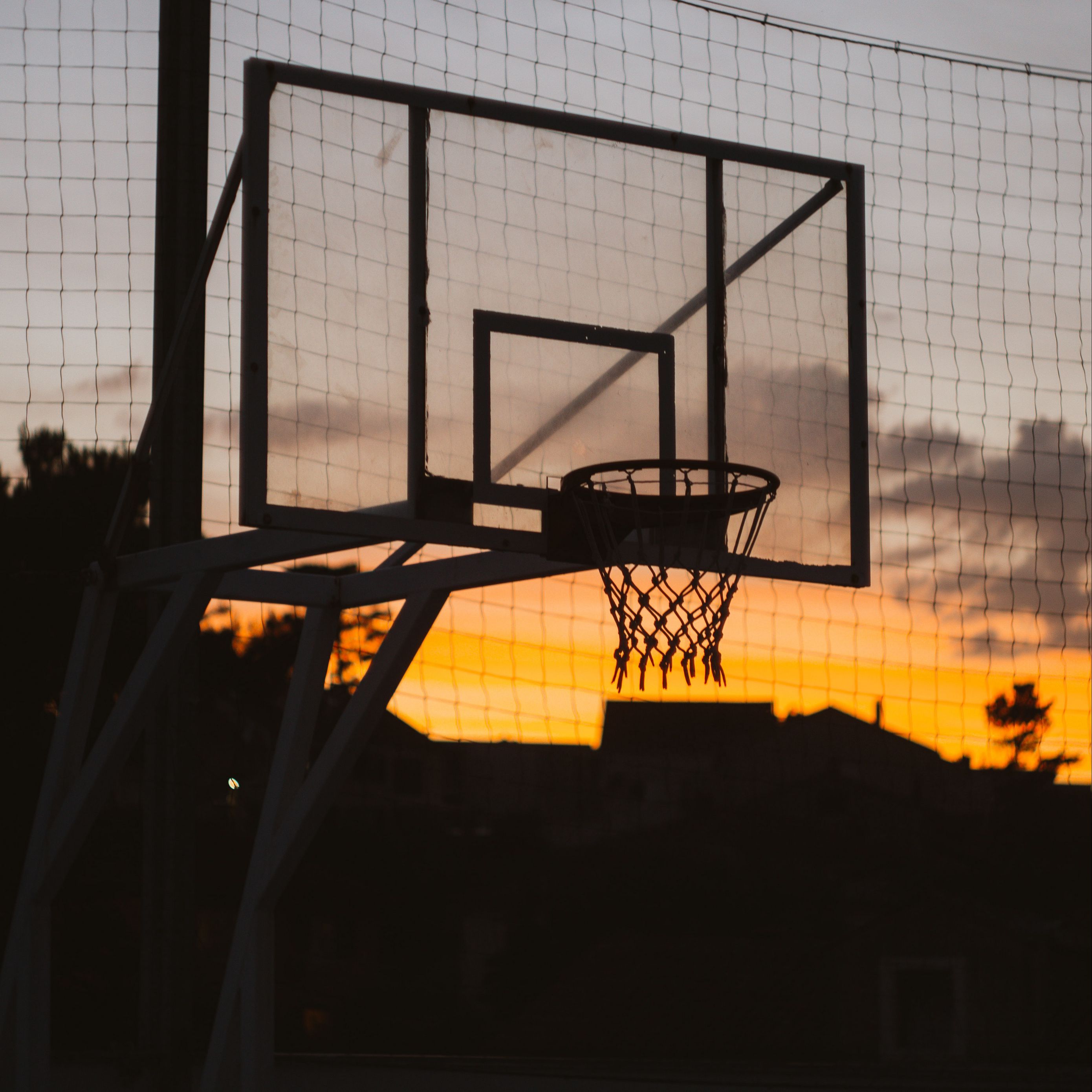 A basketball hoop in the sunset. - Basketball