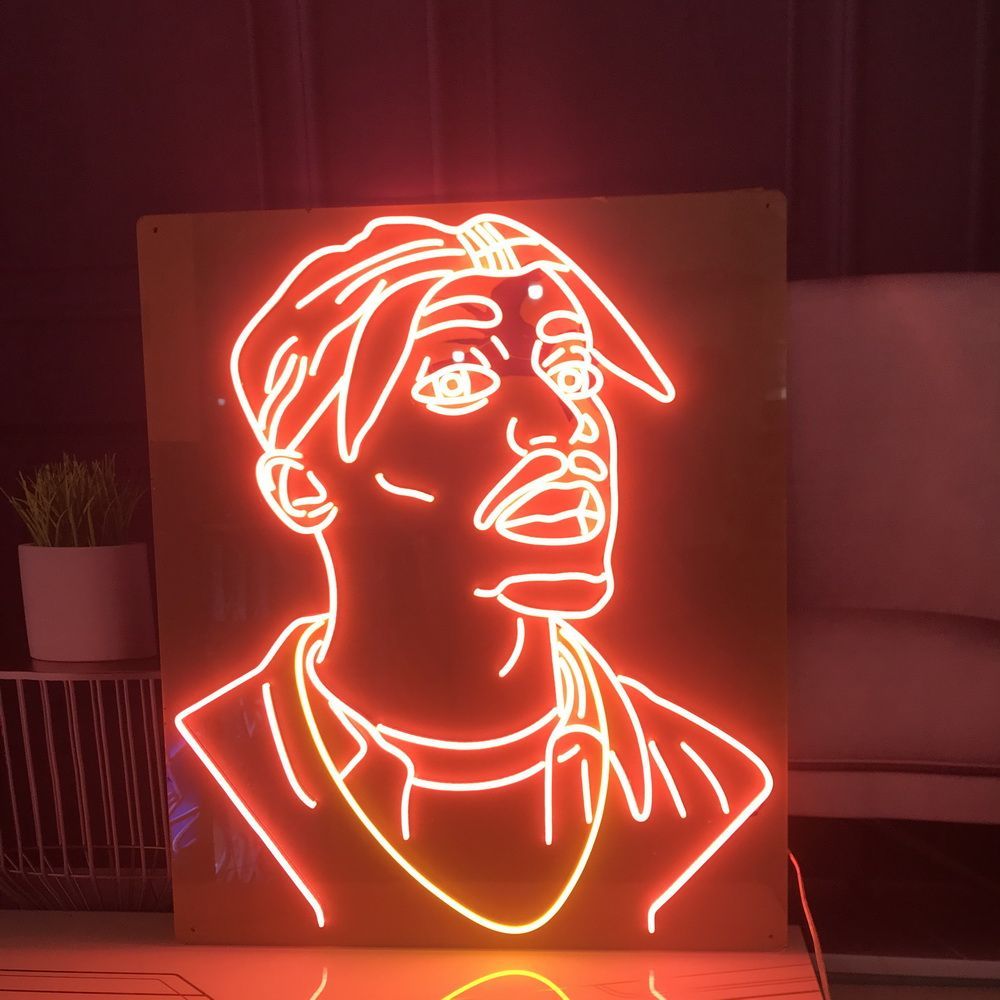 A neon sign featuring a cartoon illustration of a man with a red outline. - Neon orange