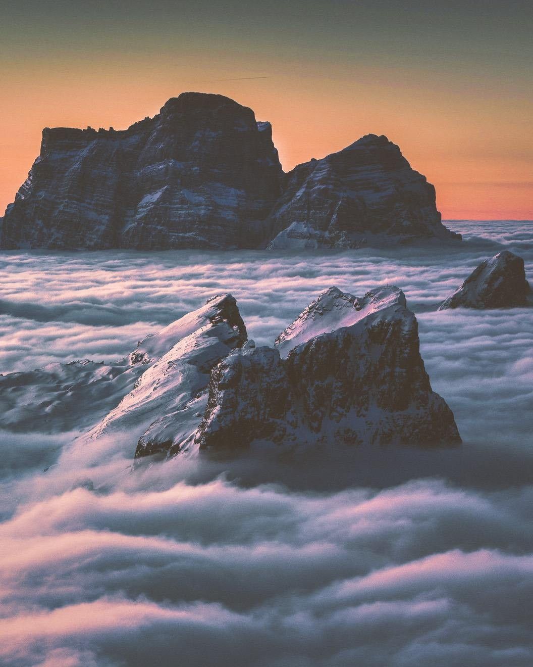 A mountain top is surrounded by clouds - Mountain