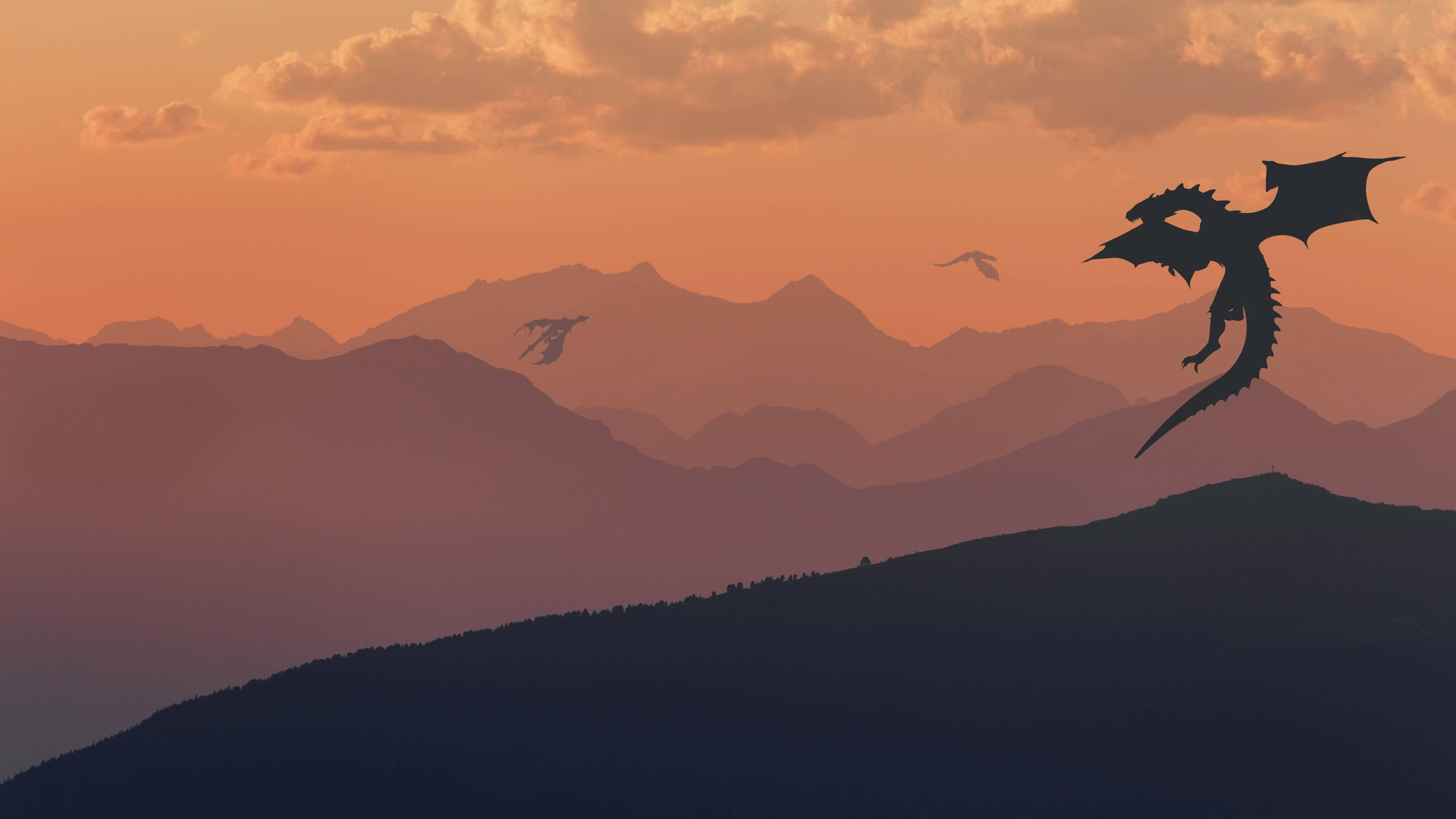 A dragon flying over the mountains at sunset - Dragon