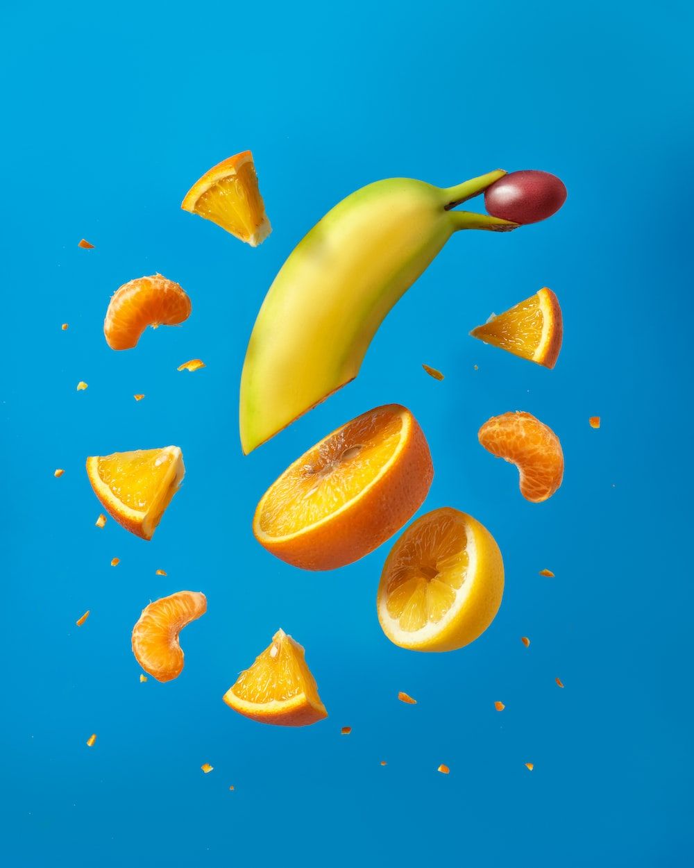 A banana and orange are falling from the sky - Foodie