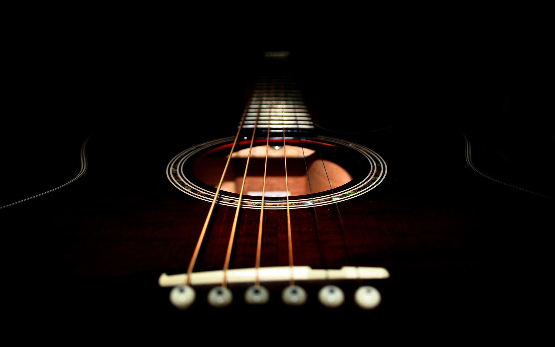 An acoustic guitar in the dark. - Guitar