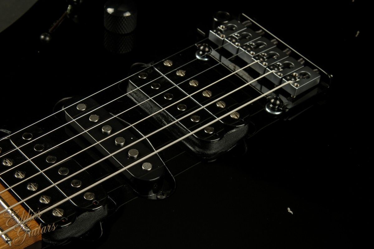 Close up of the 12 string neck on a black electric guitar - Guitar