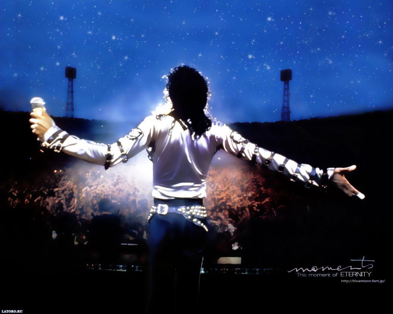 A man in white shirt and pants is standing on stage - Michael Jackson