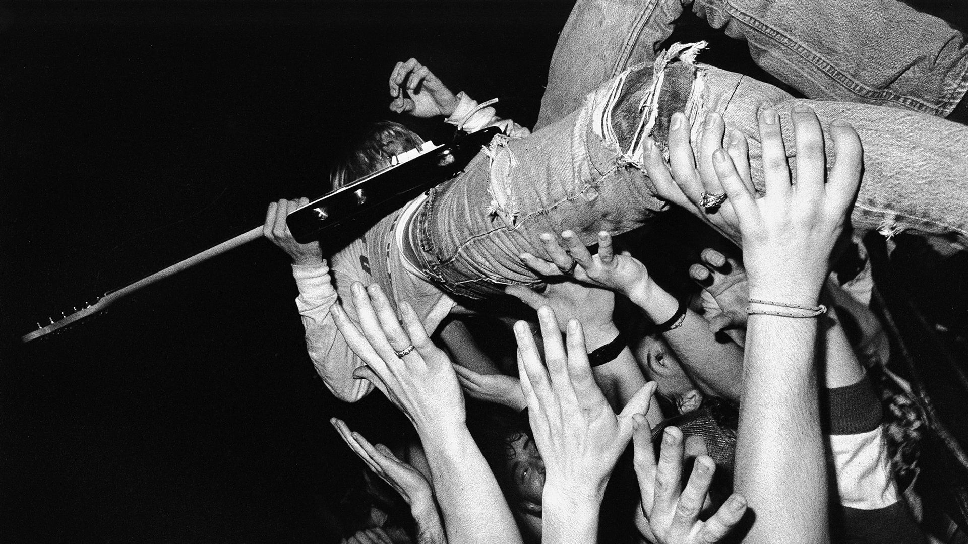 A man is being lifted up by his hands - Nirvana