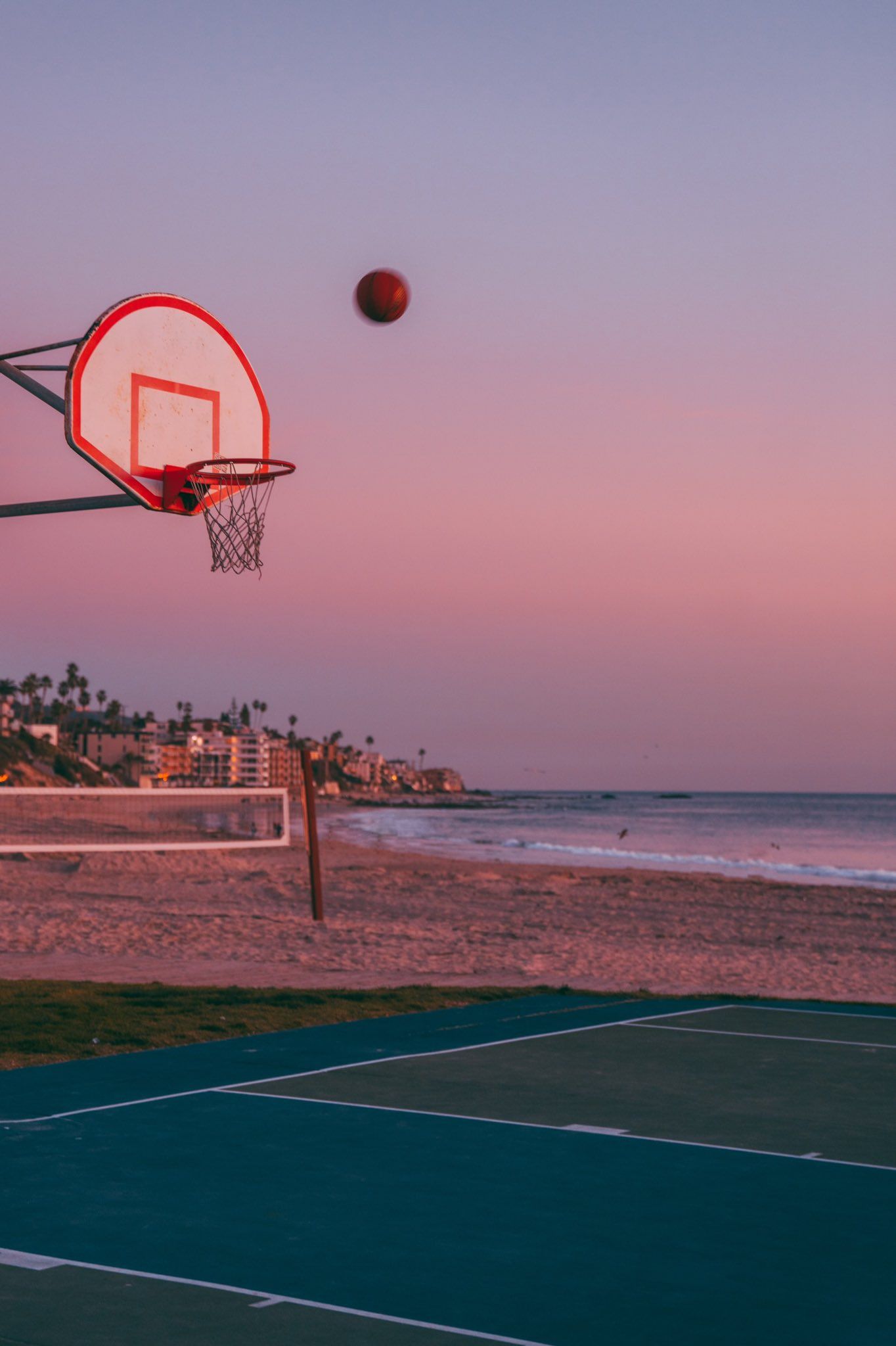 A basketball hoop on the beach with an ocean view - Basketball