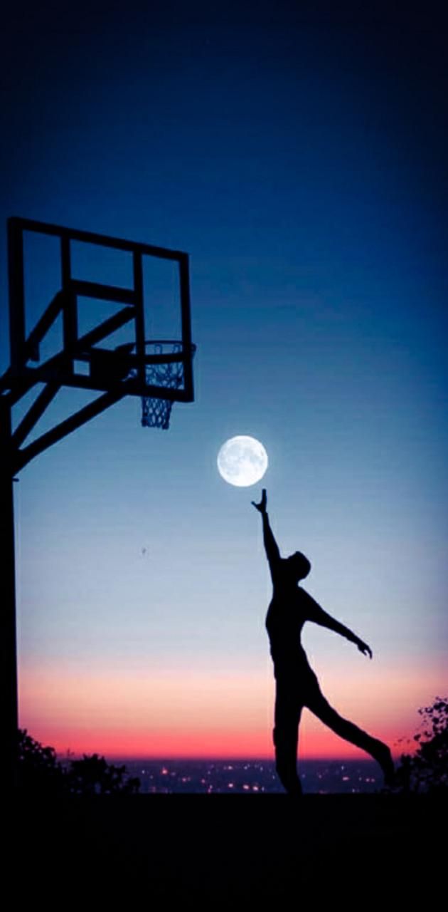 A silhouette of person playing basketball at night - Basketball