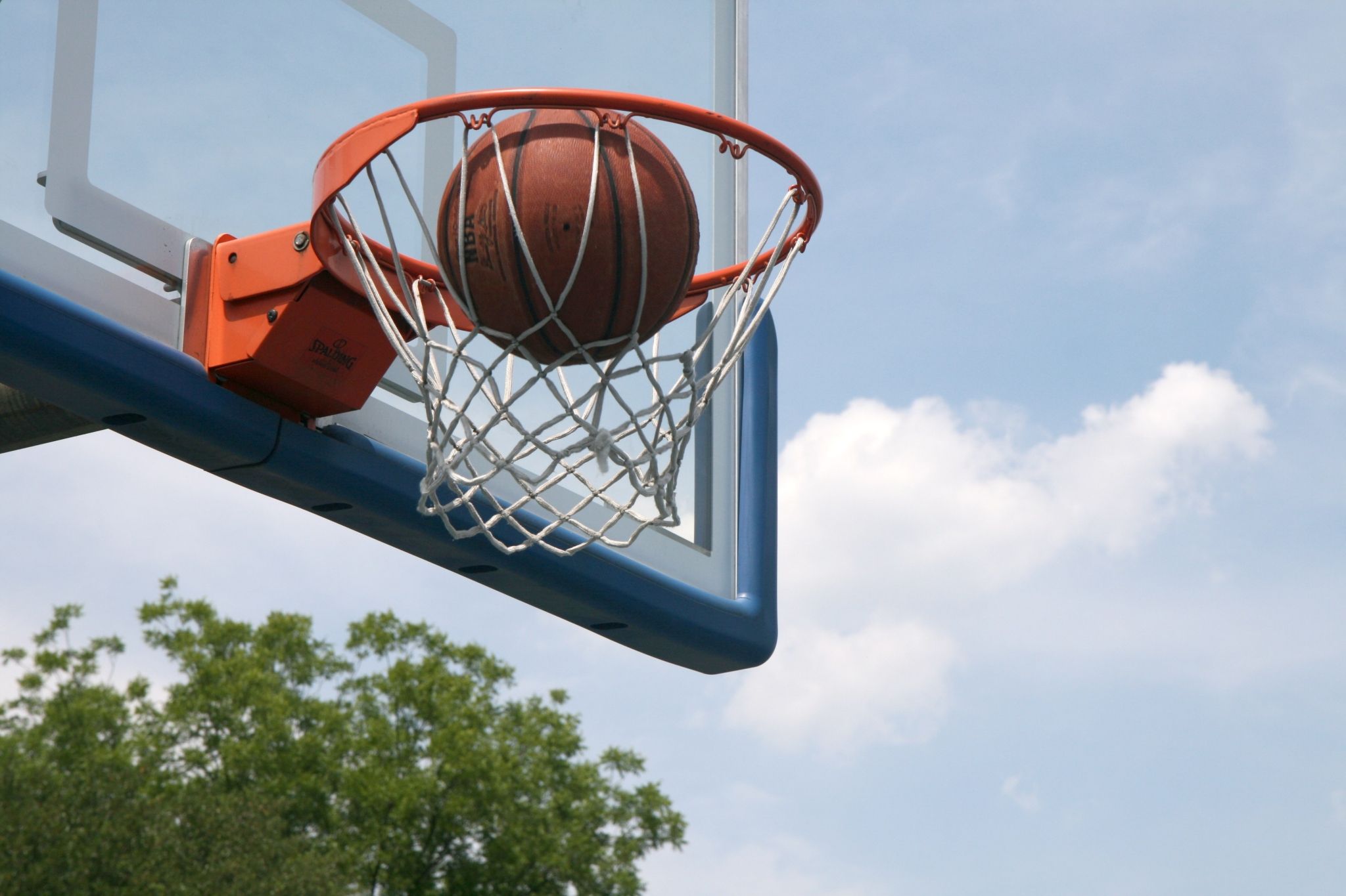 A basketball hoop with the ball in it - Basketball