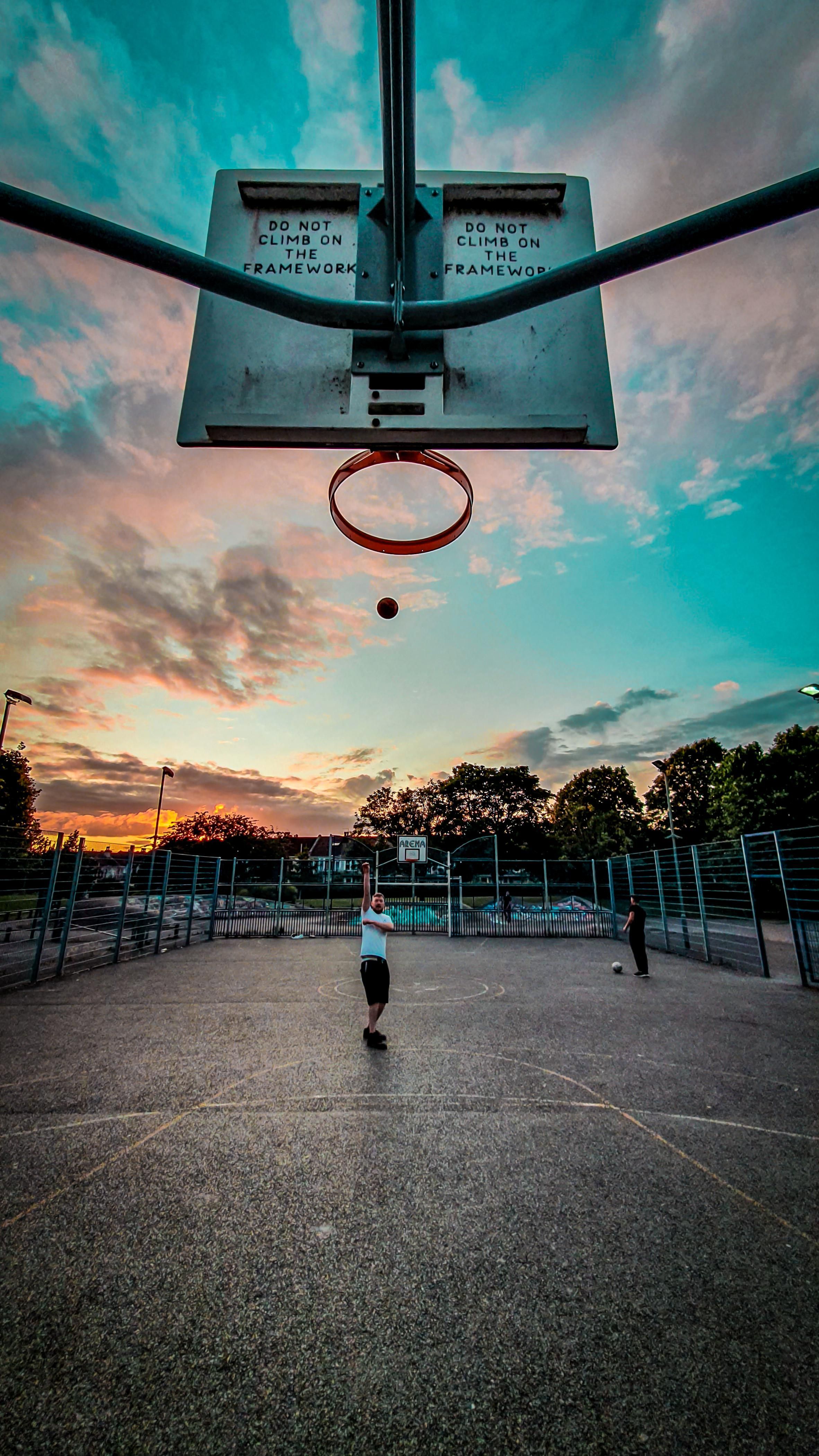 A person is playing basketball in the park - Basketball