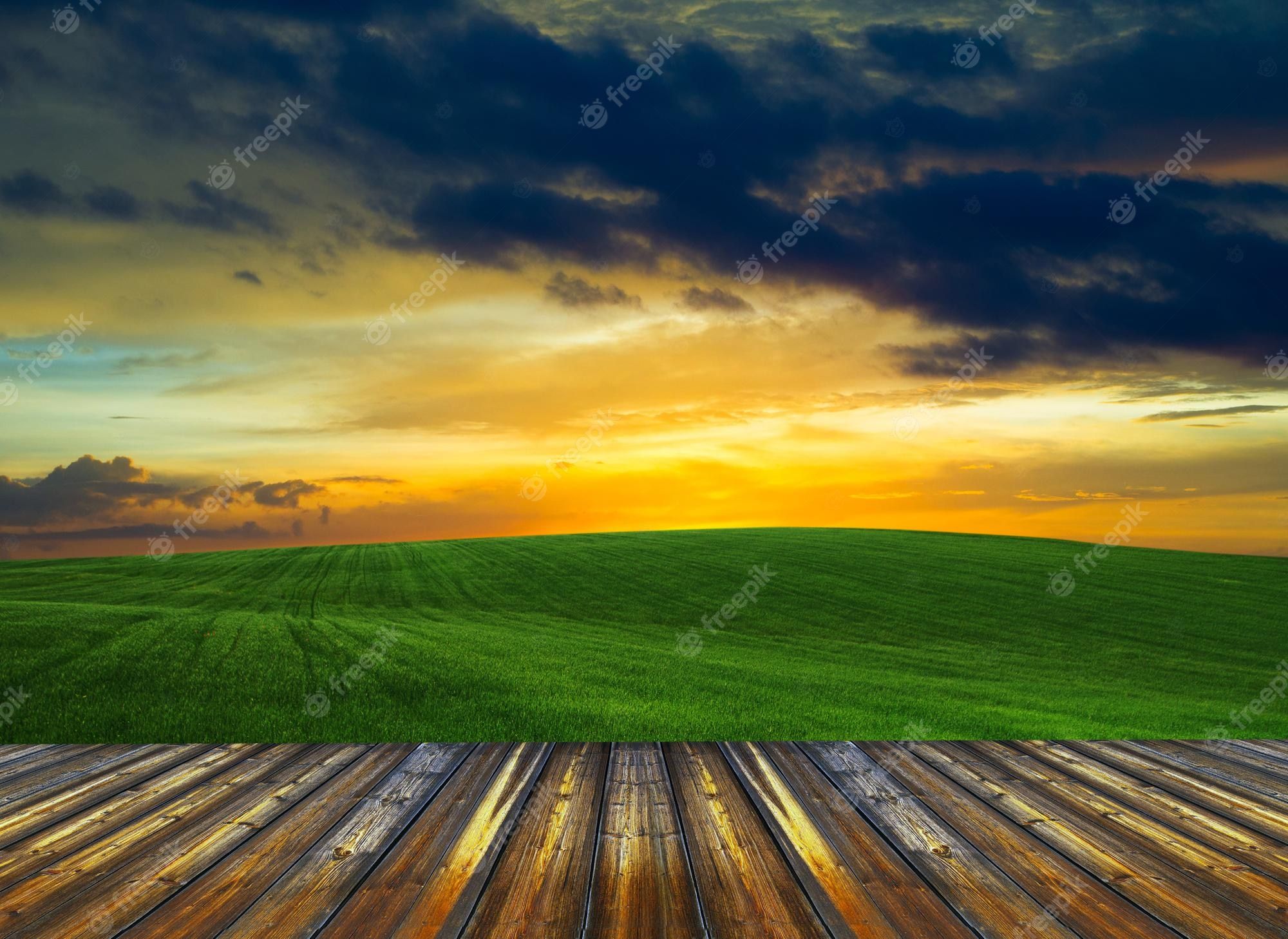 A sunset over the grassy field with wooden deck - Farm