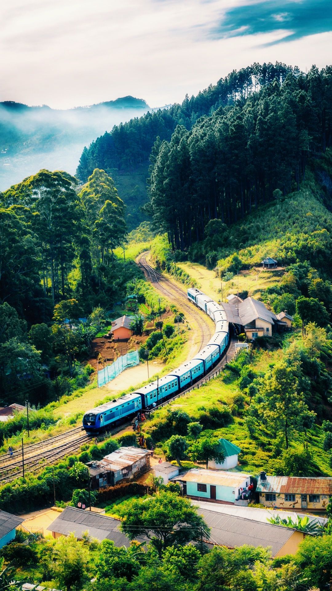 A train traveling down the tracks through some trees - Nature