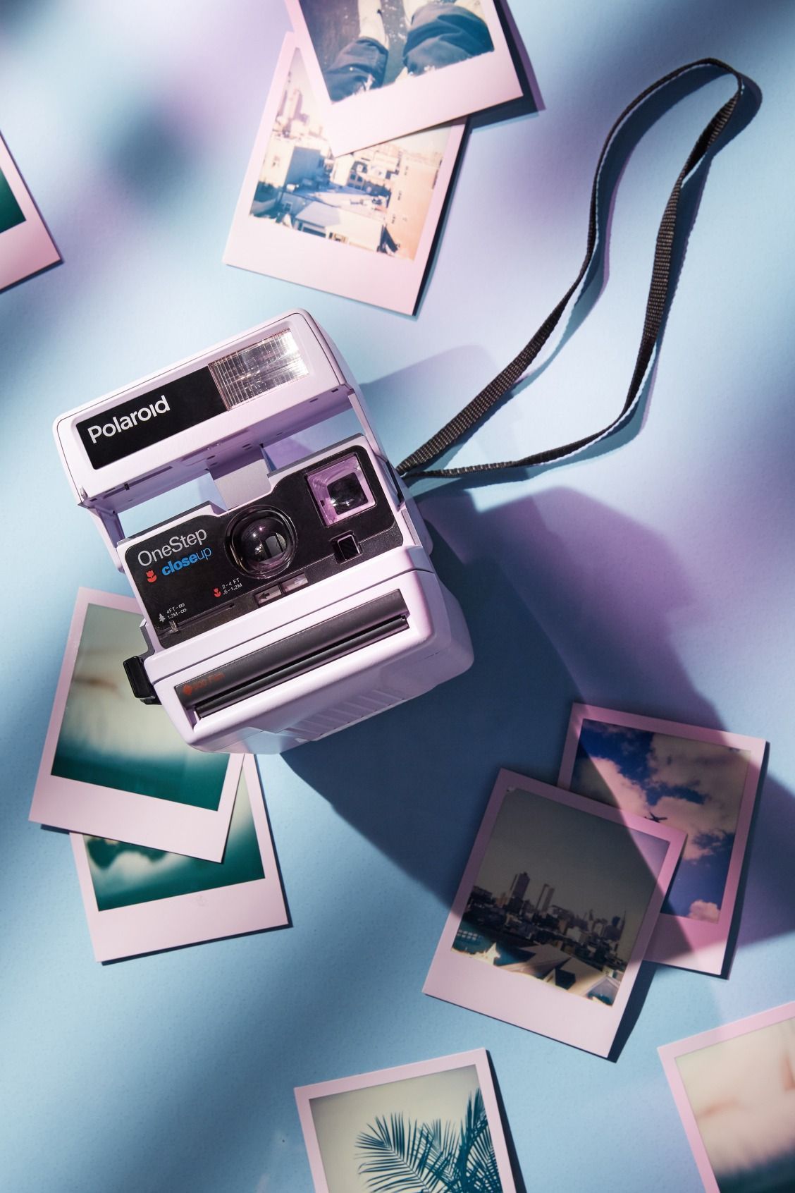 Polaroid camera with instant photos on a blue background - Polaroid