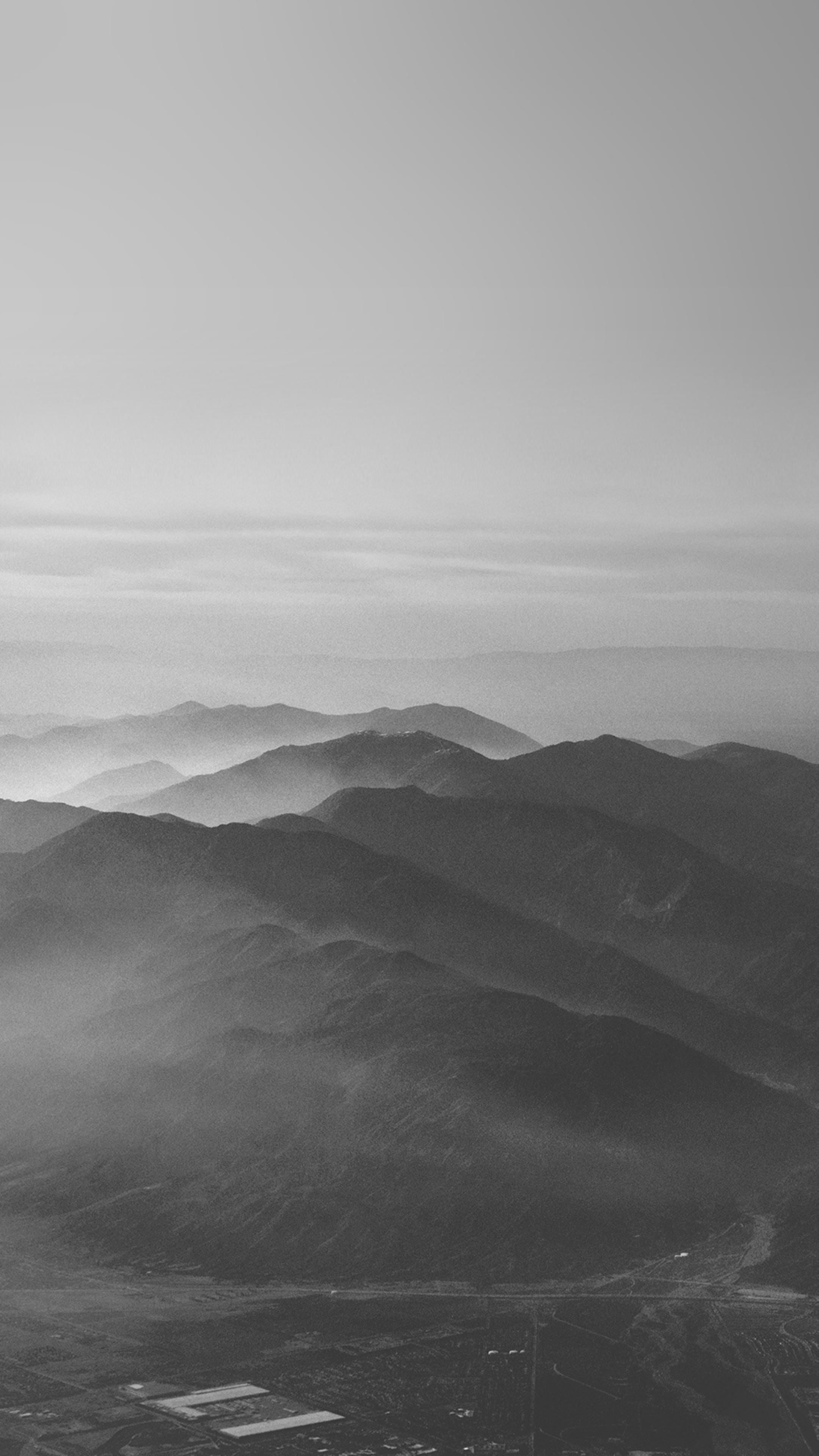 A black and white image of a mountain range - Nature, fog