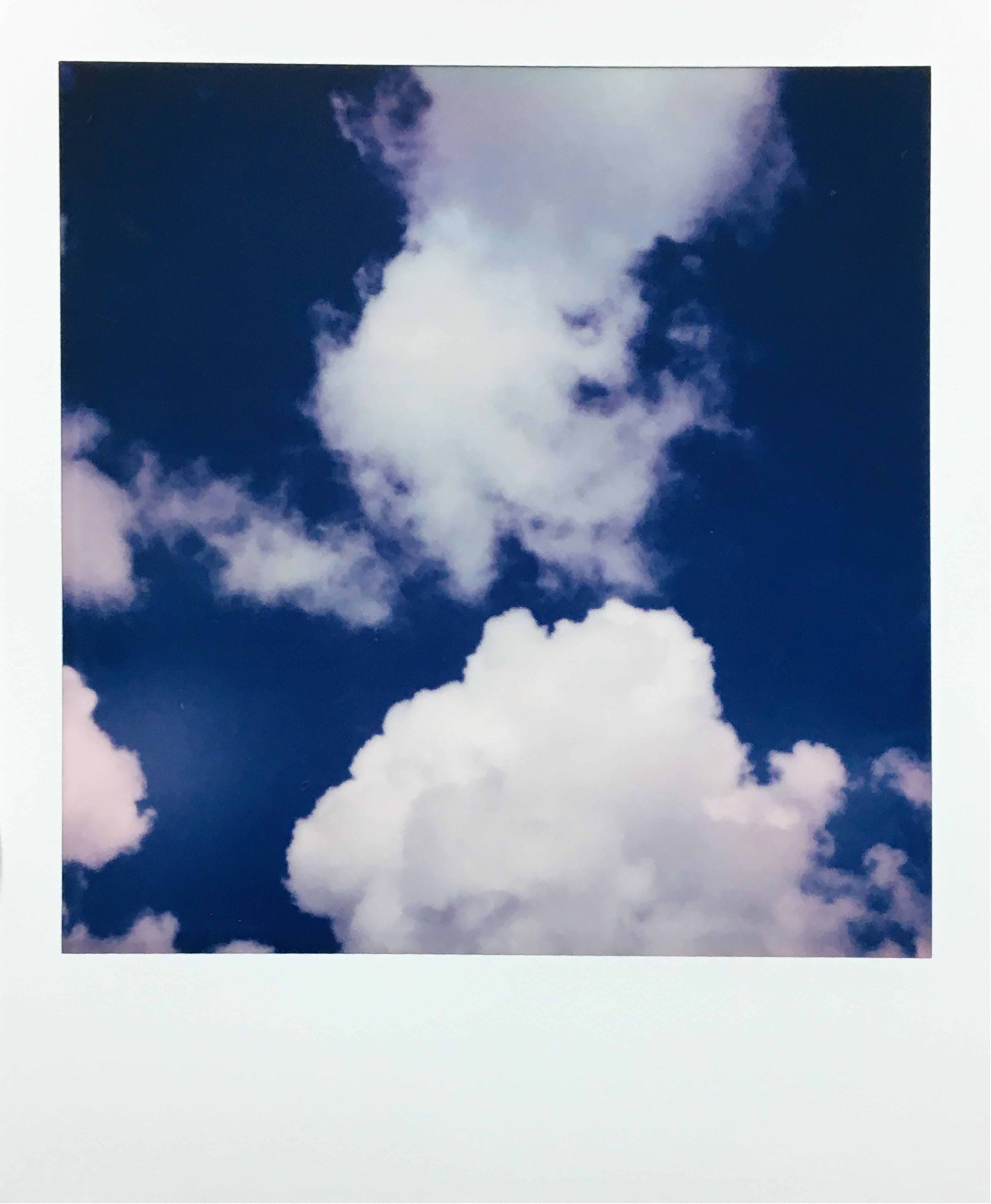 A picture of clouds and blue sky - Polaroid