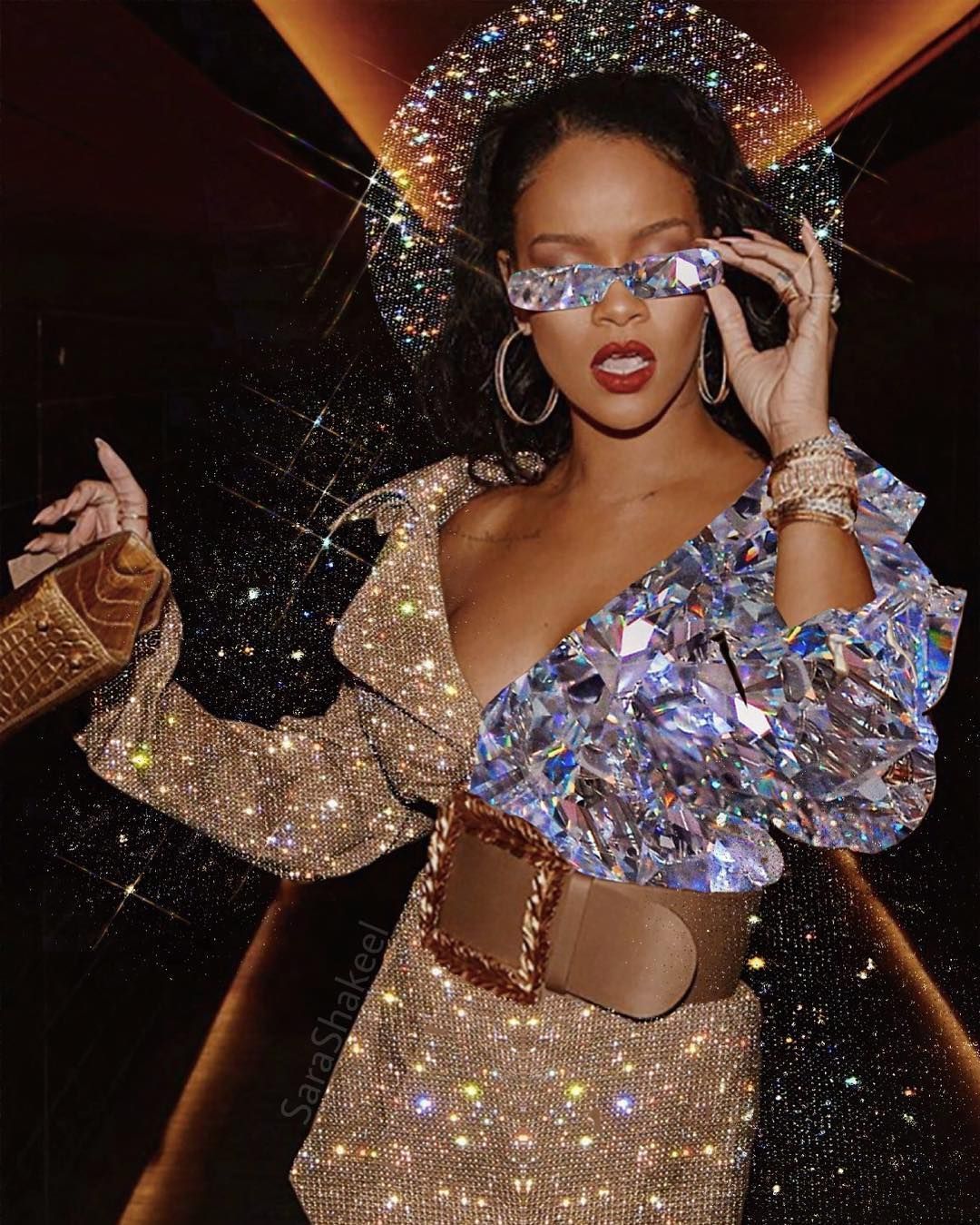 Rihanna in a gold, silver and brown outfit with a belt and a diamond bag - Rihanna
