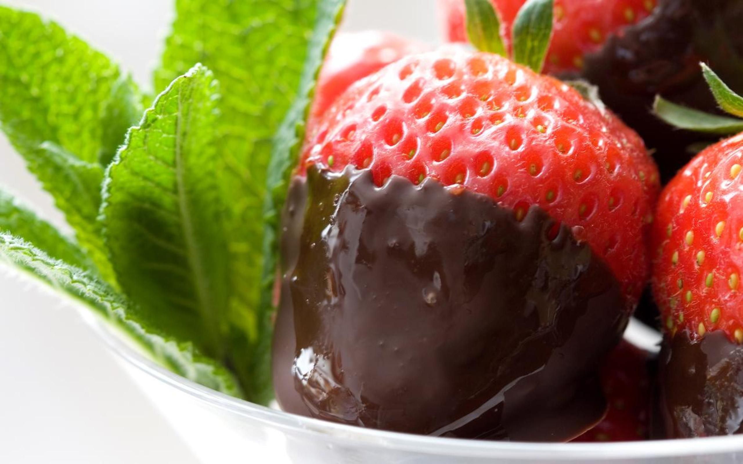 A bowl of chocolate-covered strawberries with mint leaves - Strawberry, chocolate