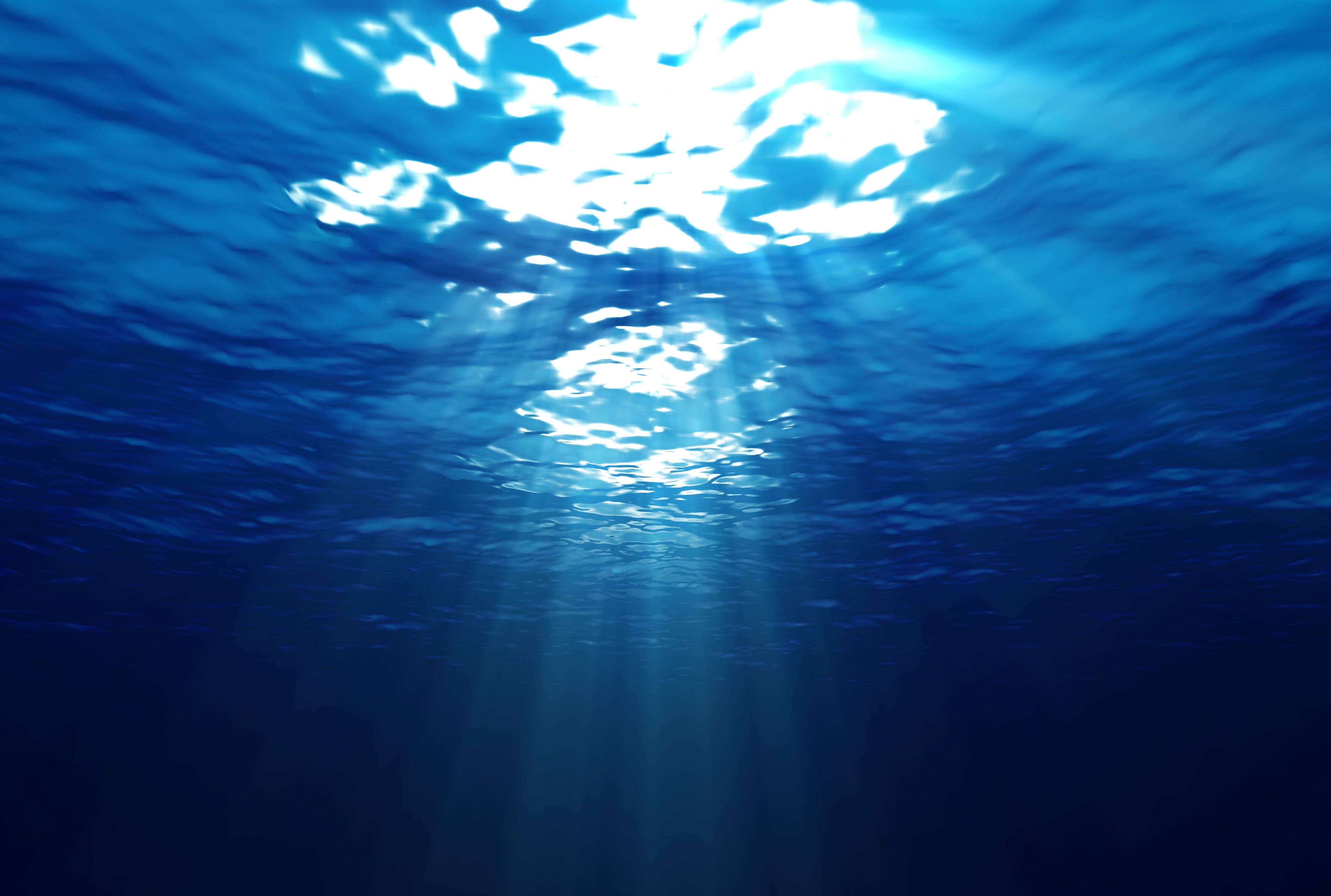 A sun ray is shining through the water - Underwater