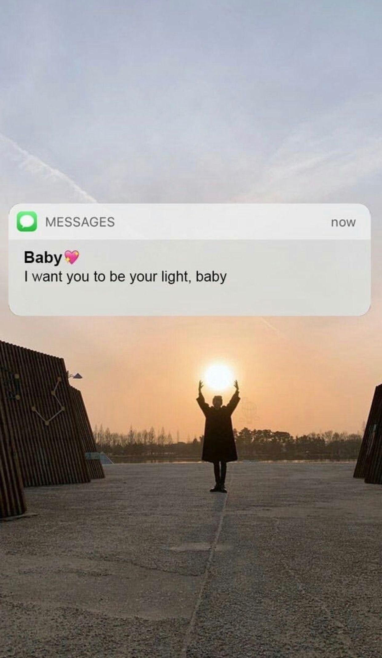 A person standing in front of the sun with a text message that says 