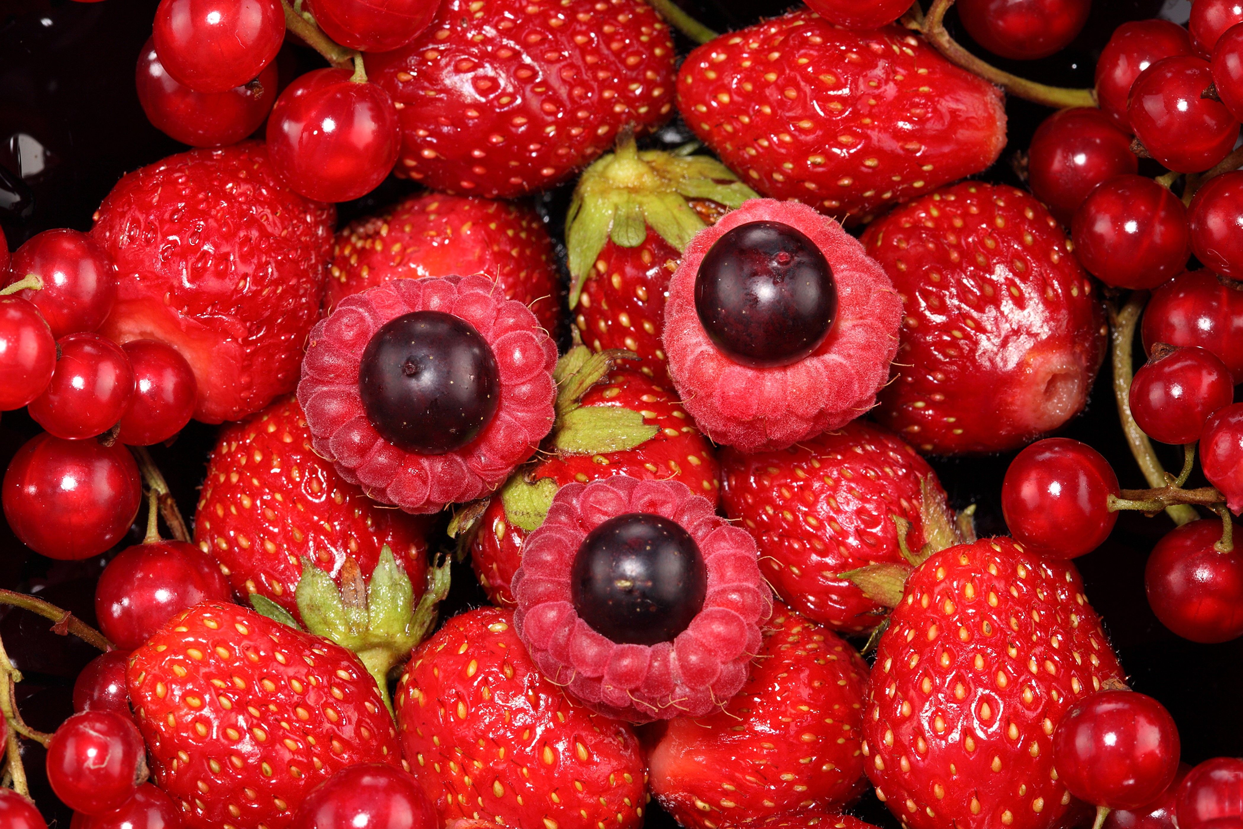 A pile of strawberries, raspberries, and redcurrants. - Strawberry