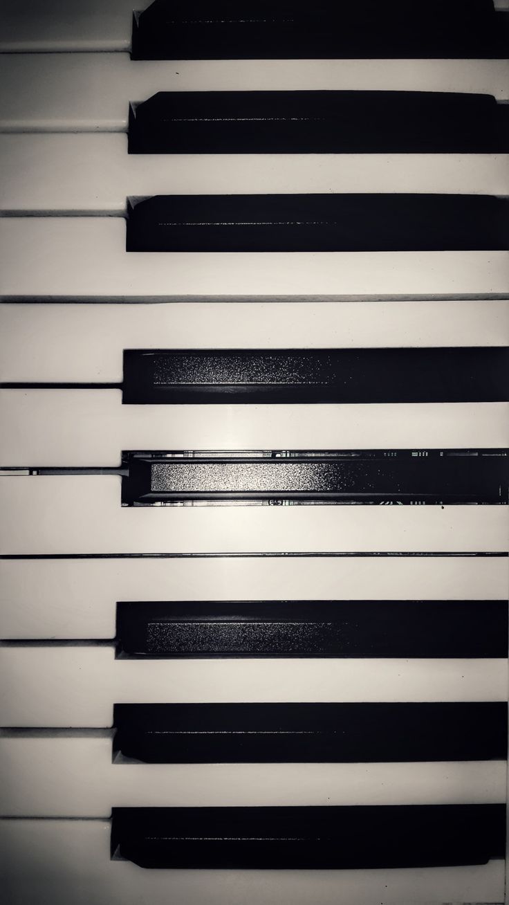 Close up of piano keys, with a focus on the middle C key. - Piano