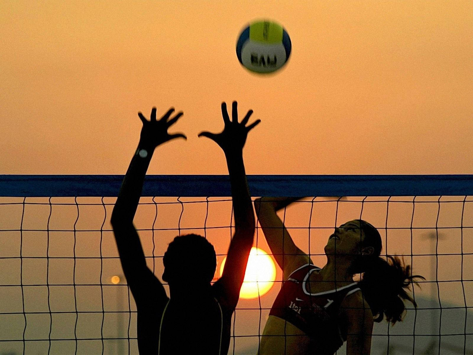 Download Beach Volleyball In Motion Blur At Sunset Wallpaper