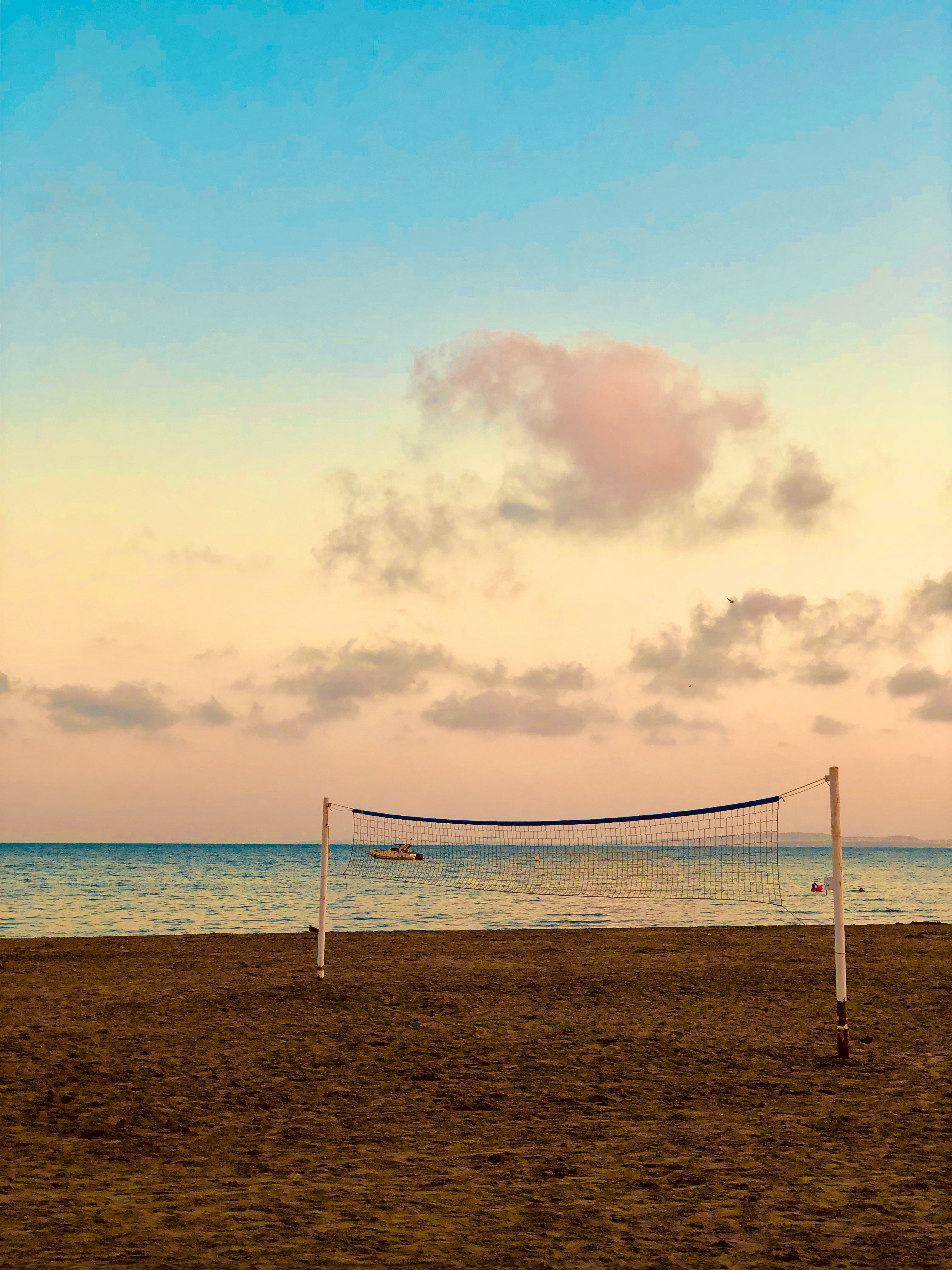 Volleyball net on the beach during sunset - Volleyball