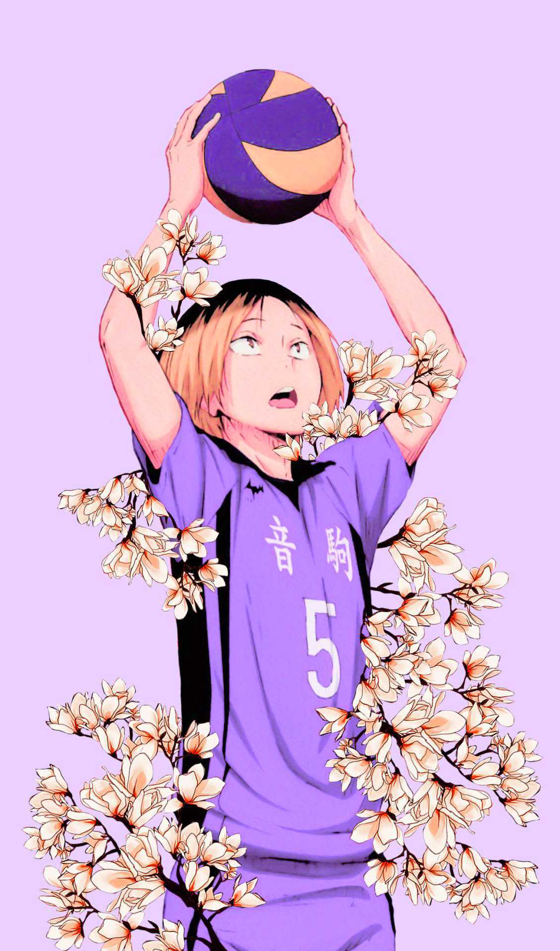 A girl in purple holding up an orange ball with flowers - Volleyball