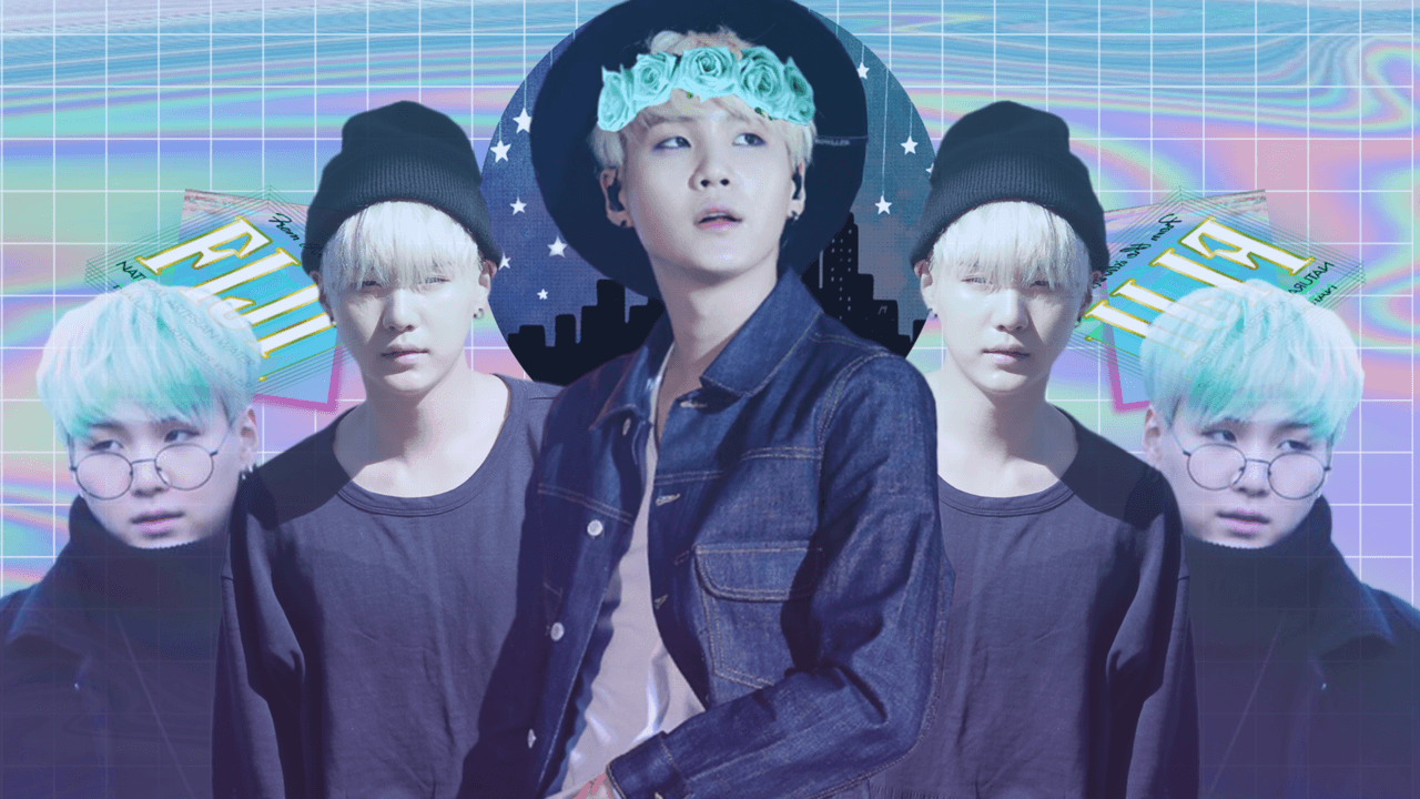 A collage of Suga from BTS wearing a denim jacket and a black hat with a white rose on it. He is surrounded by 4 copies of himself wearing black beanies and glasses. The background is a rainbow gradient. - BTS
