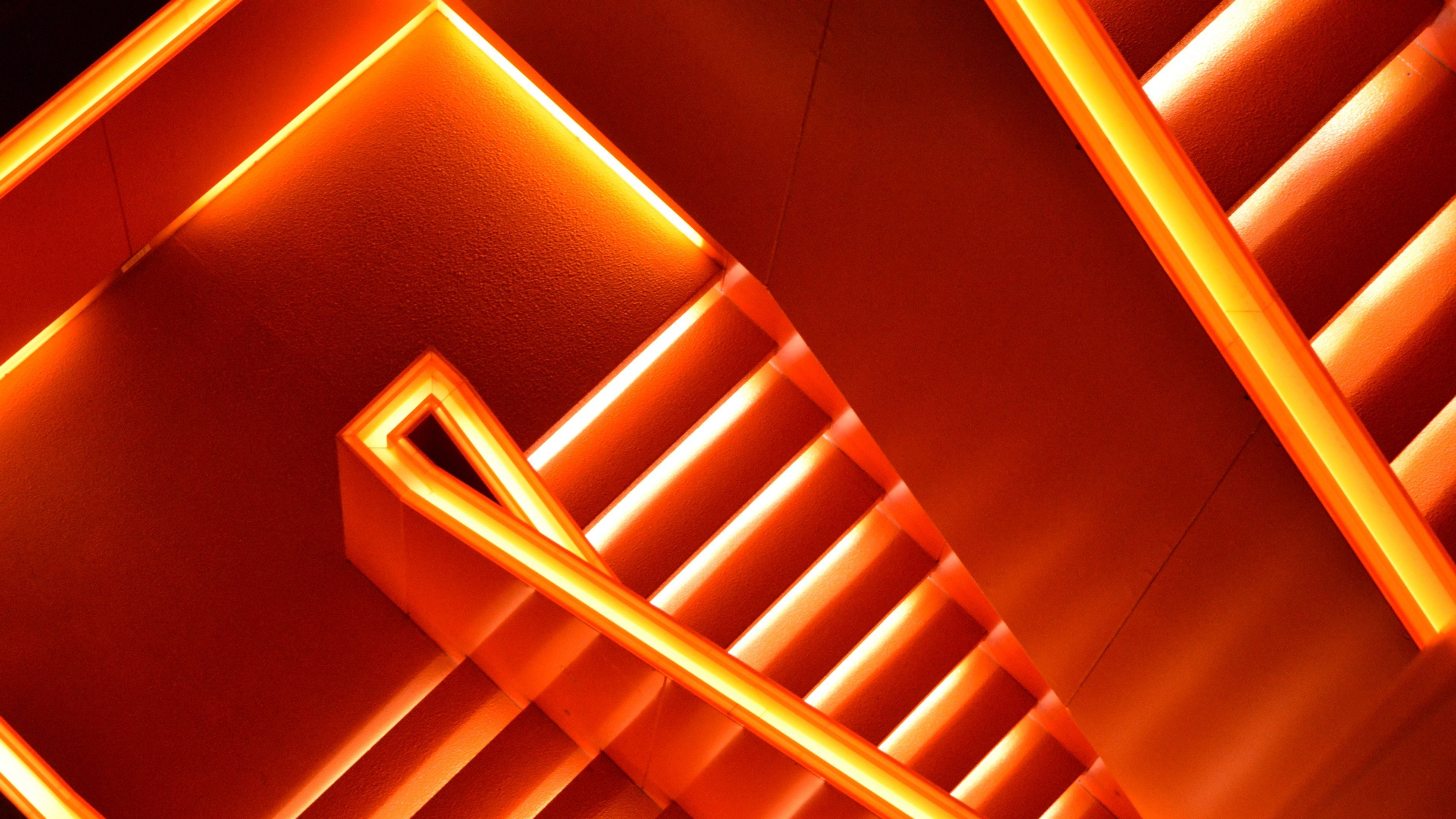 A photo of a staircase with orange lights. - Neon orange