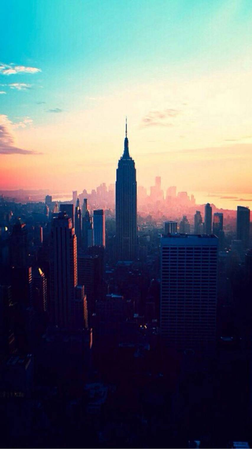 A cityscape of the skyline of New York City at sunset - City