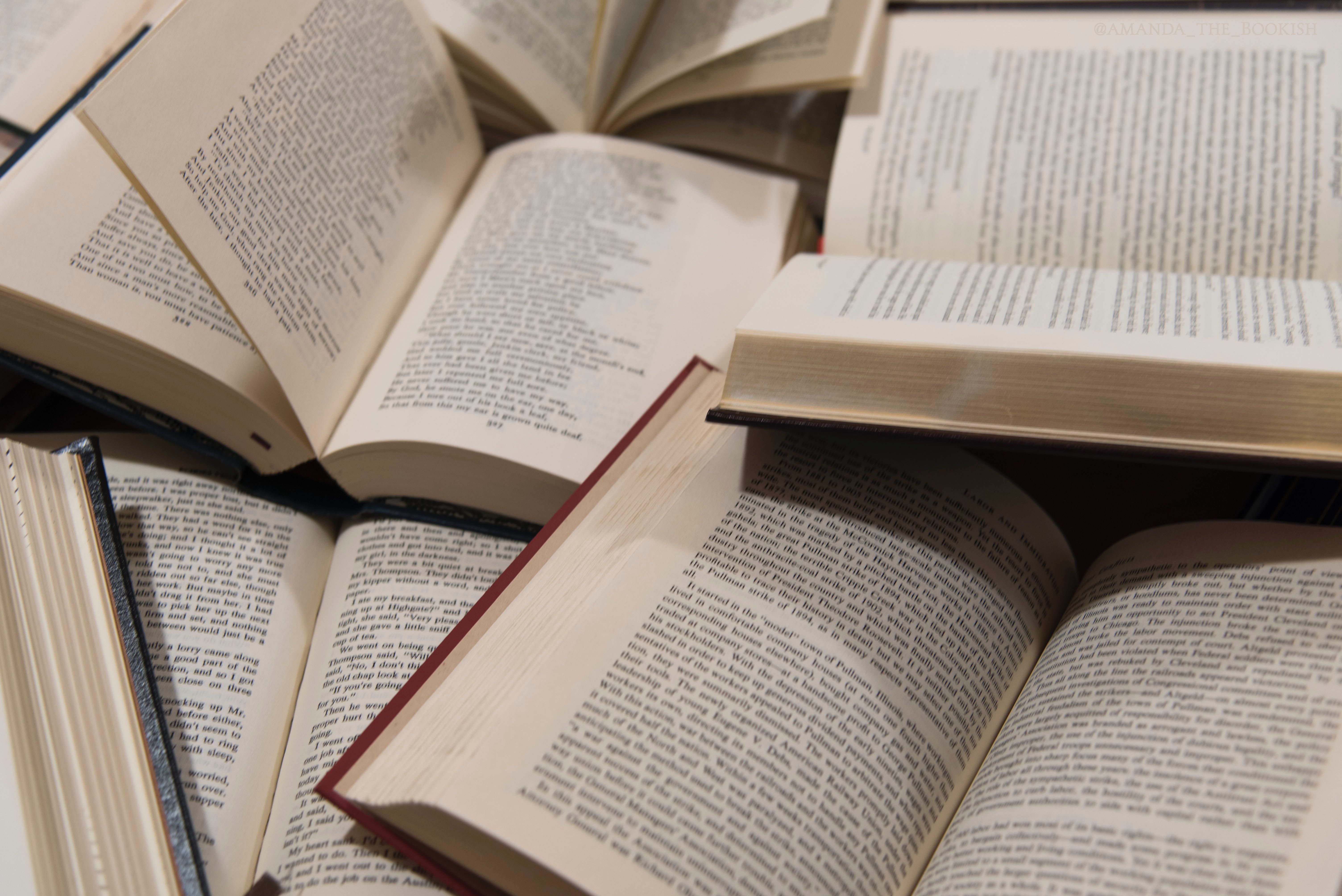 A pile of books with some open and others closed - Books