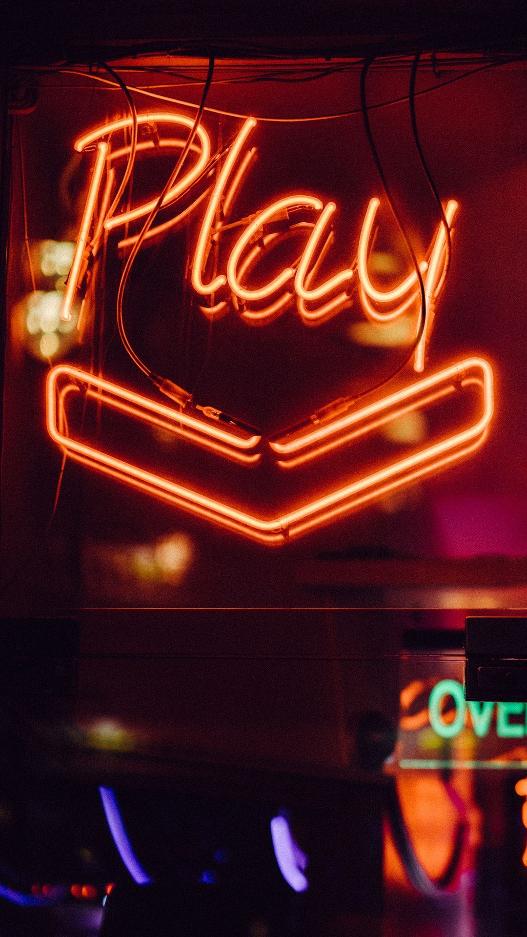 A neon sign that says play - Neon orange