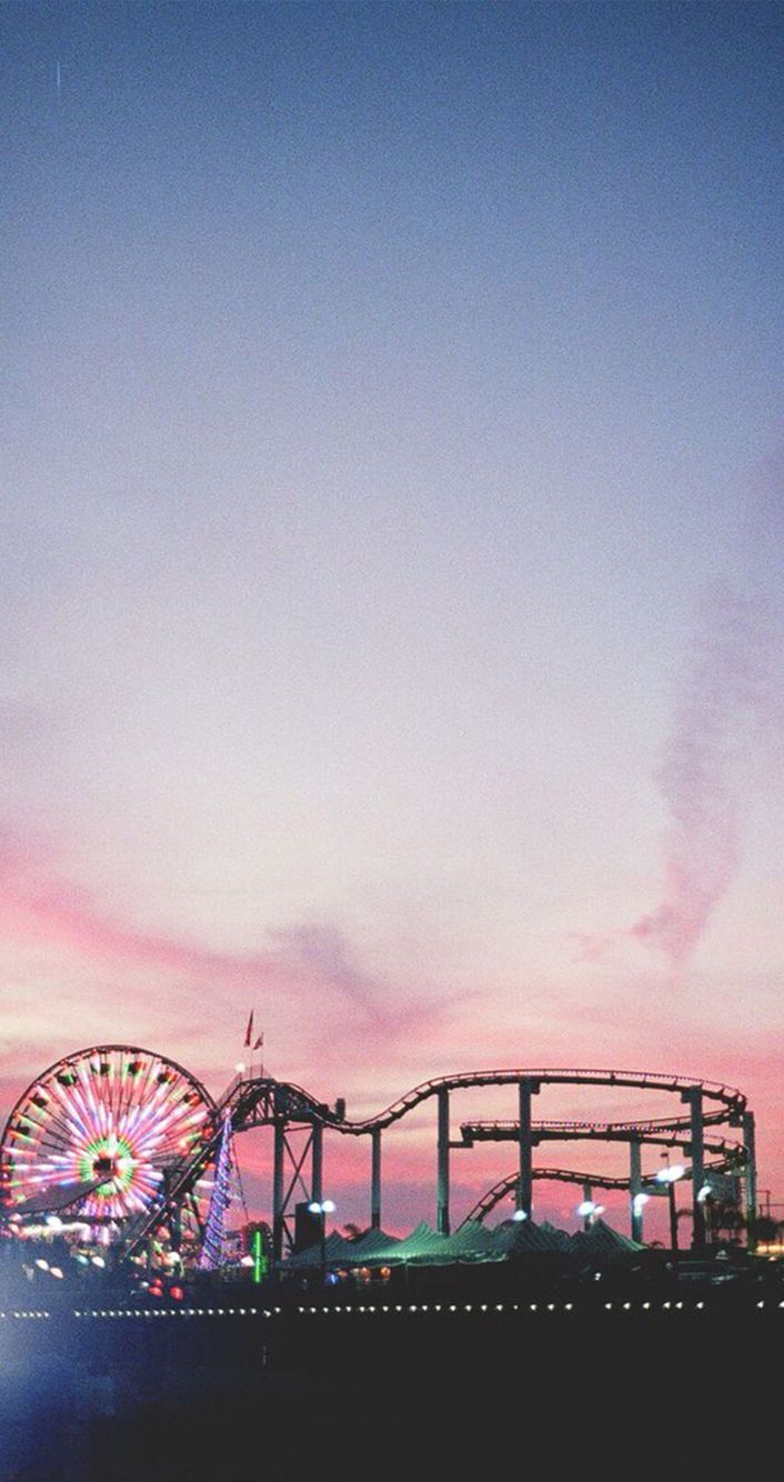 A ferris wheel and roller coaster at sunset - Sunset