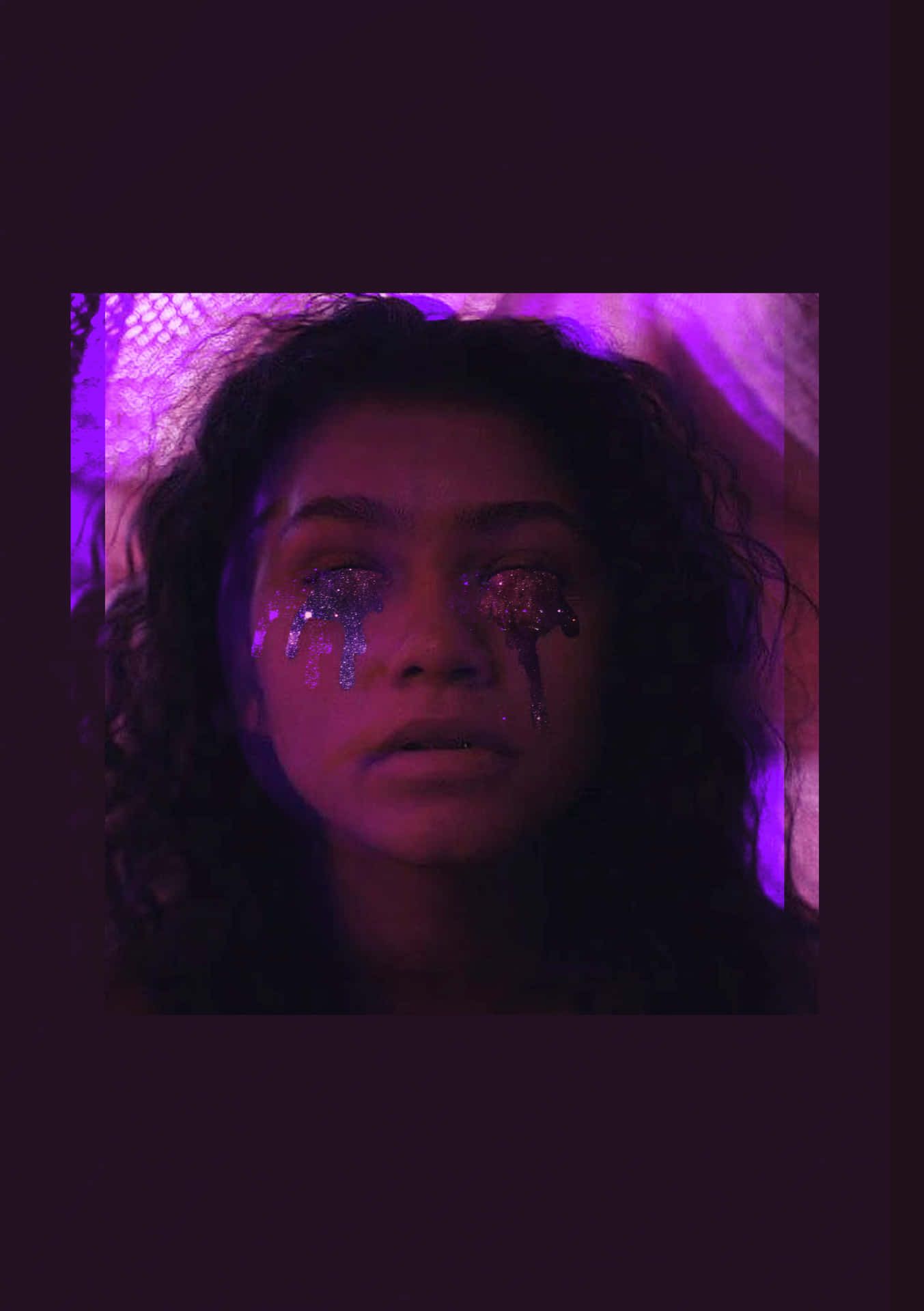 A woman with glitter on her face and purple lighting. - Euphoria
