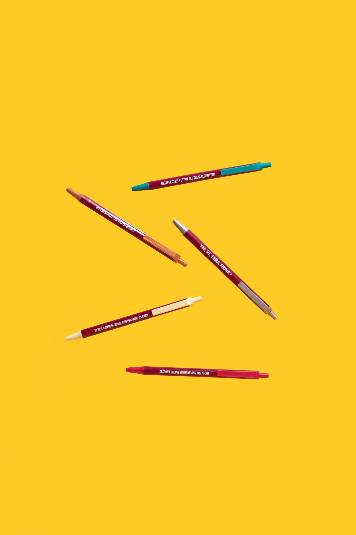 Six pens of different colors on a yellow background - Funny