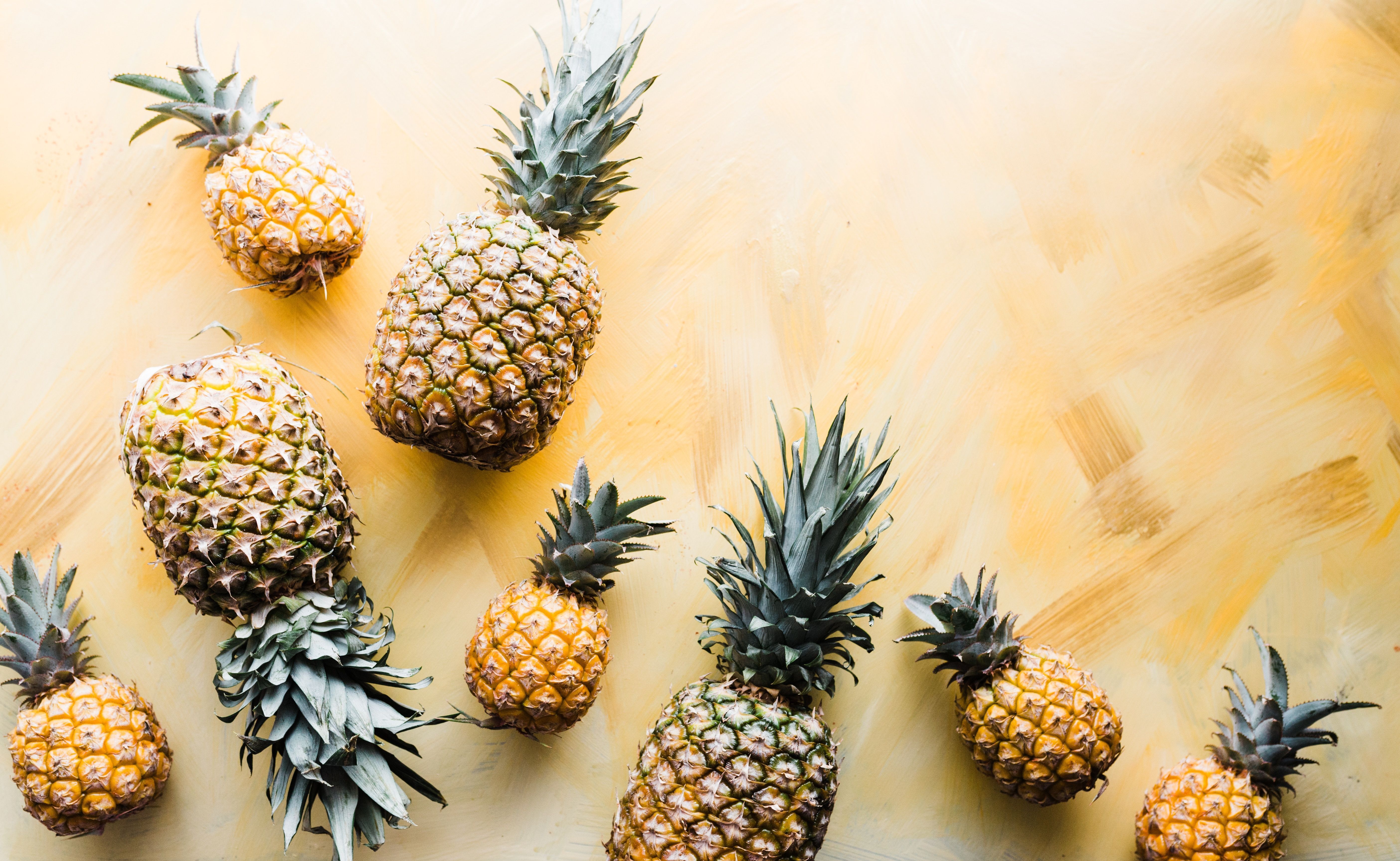 A picture of pineapples on a yellow background - Pineapple, fruit