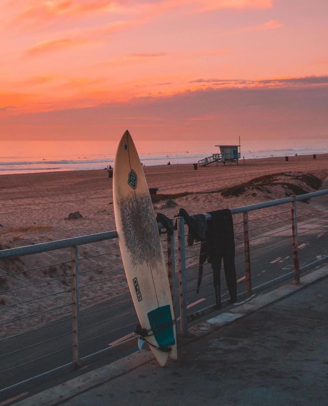 A surfboard is leaning against the fence - Surf