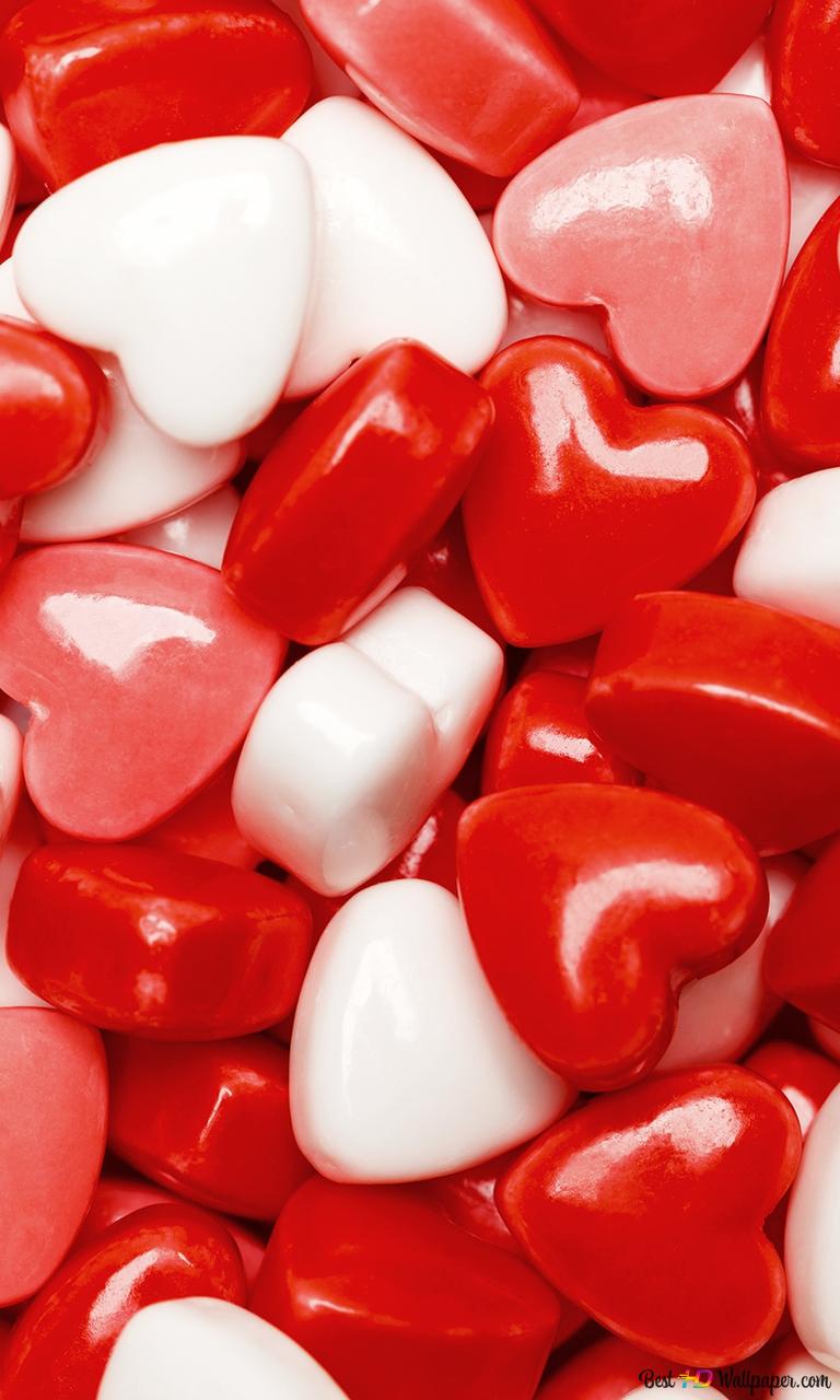 A close up of red and white candy hearts. - Candy