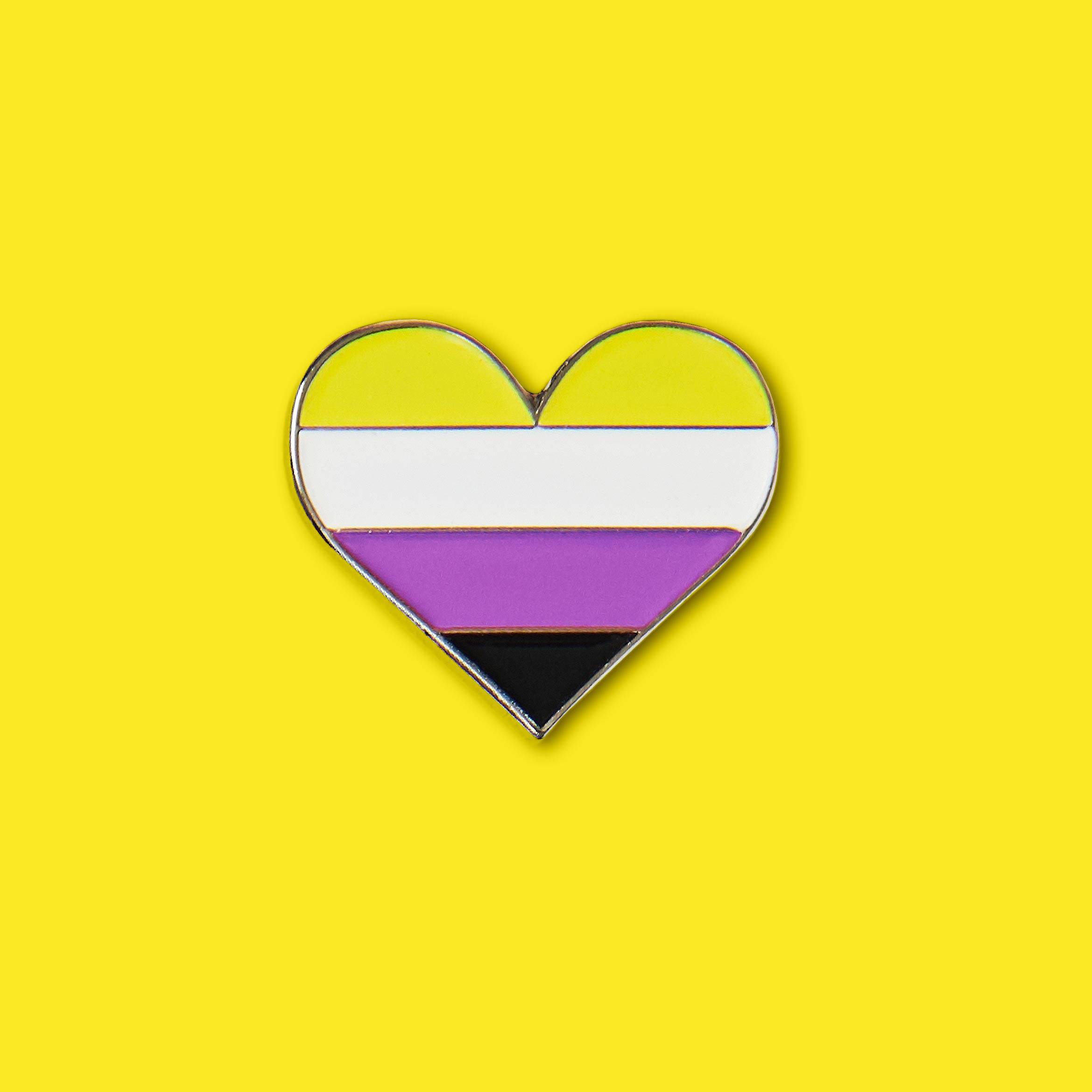 A rainbow heart pin on yellow - Non binary