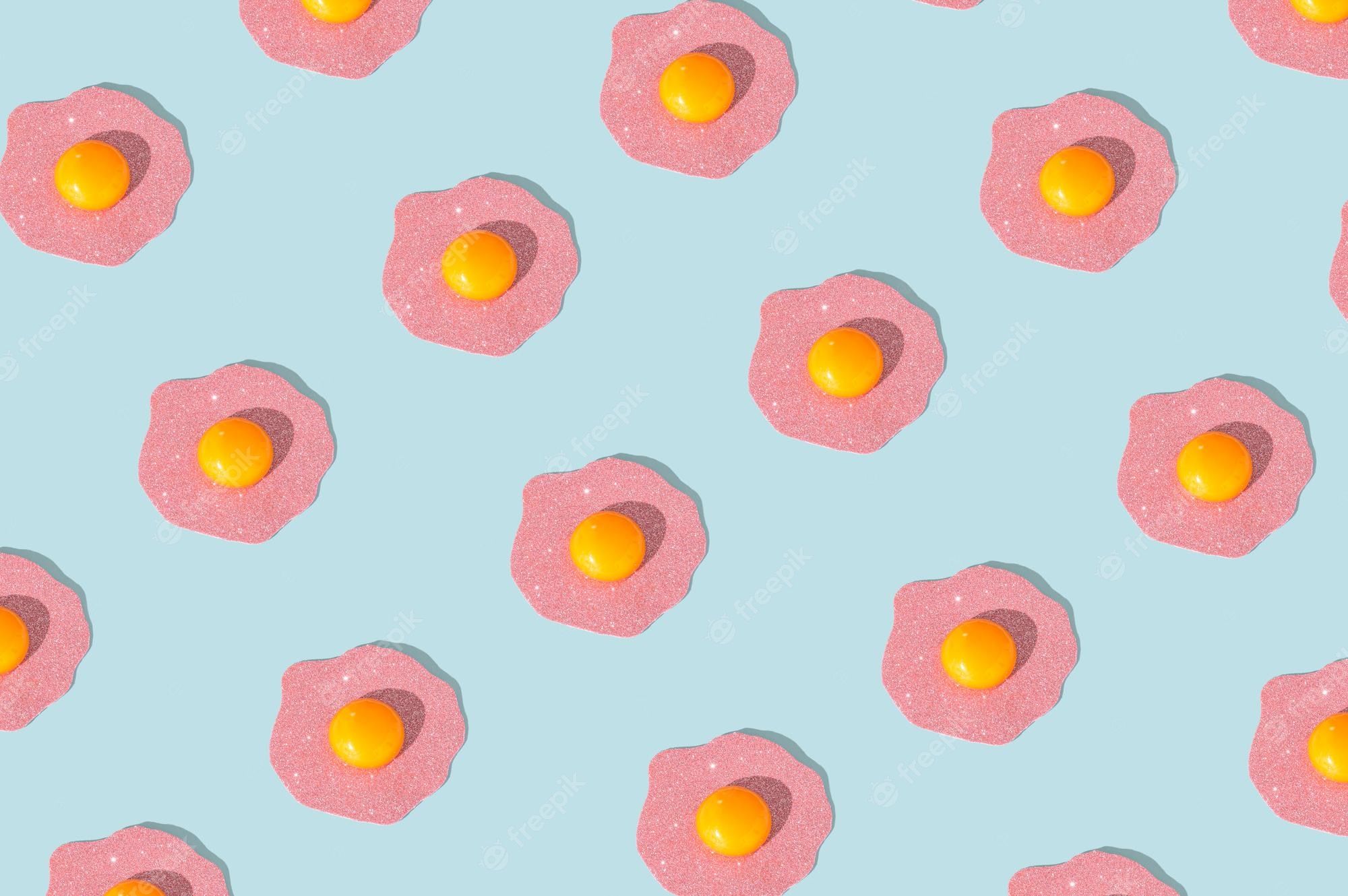 Fried eggs pattern made of pink sugar on a pastel blue background. - Egg