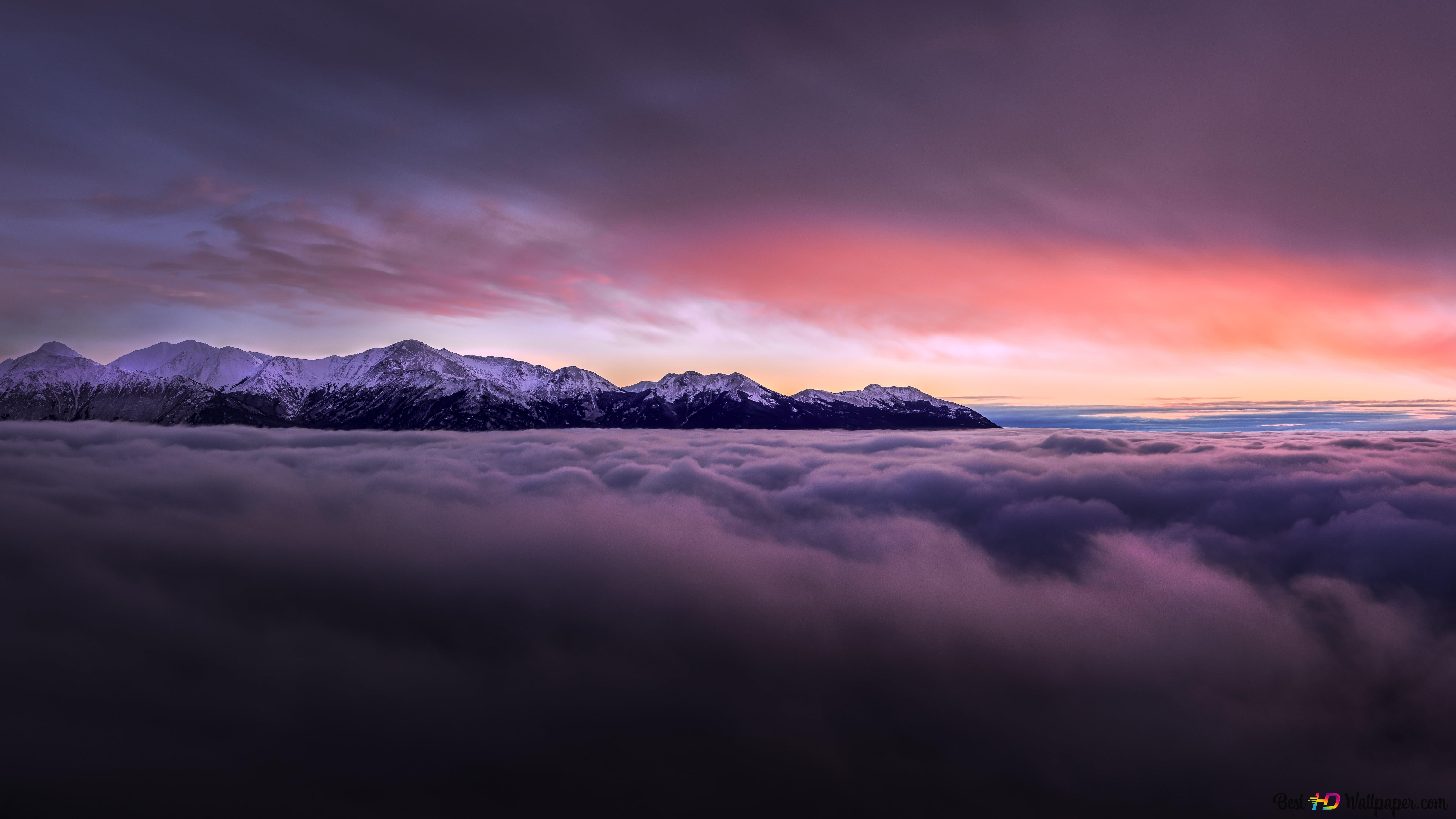Snowy mountain peaks amid mist stretching to crimson clouds 8K wallpaper download