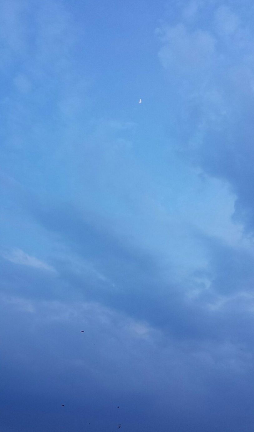 A blue sky with a crescent moon and some clouds. - Calming