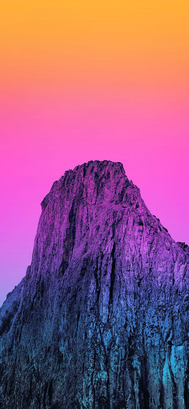 A mountain is shown in front of an orange sky - Mountain, rocks, sunset