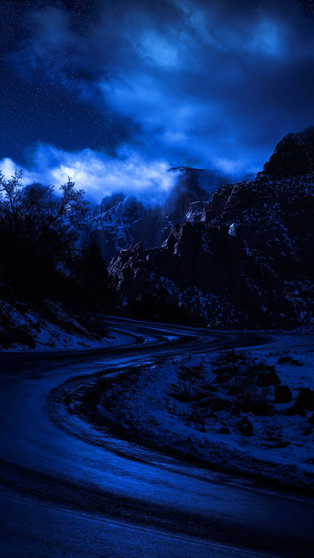 Nighttime shot of a mountain road - Dark blue, navy blue