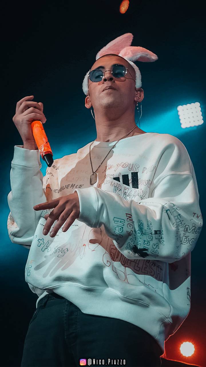 The young Mexican singer, J Balvin, performing on stage in a white sweatshirt. - Bad Bunny