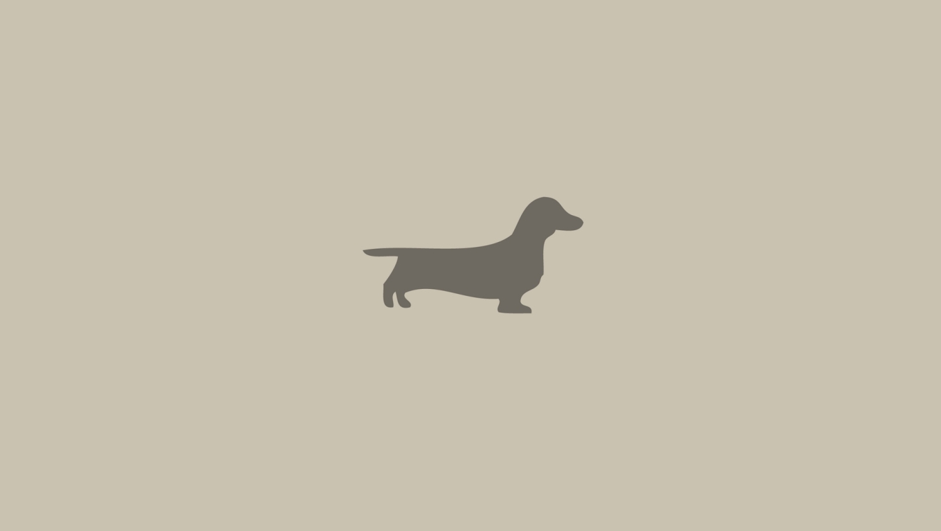 A silhouette of a dachshund on a tan background - Dog