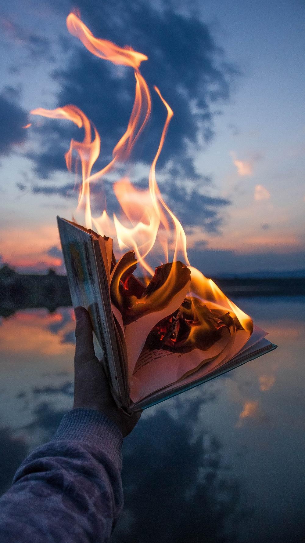 Person holding a book on fire - Fire, flames