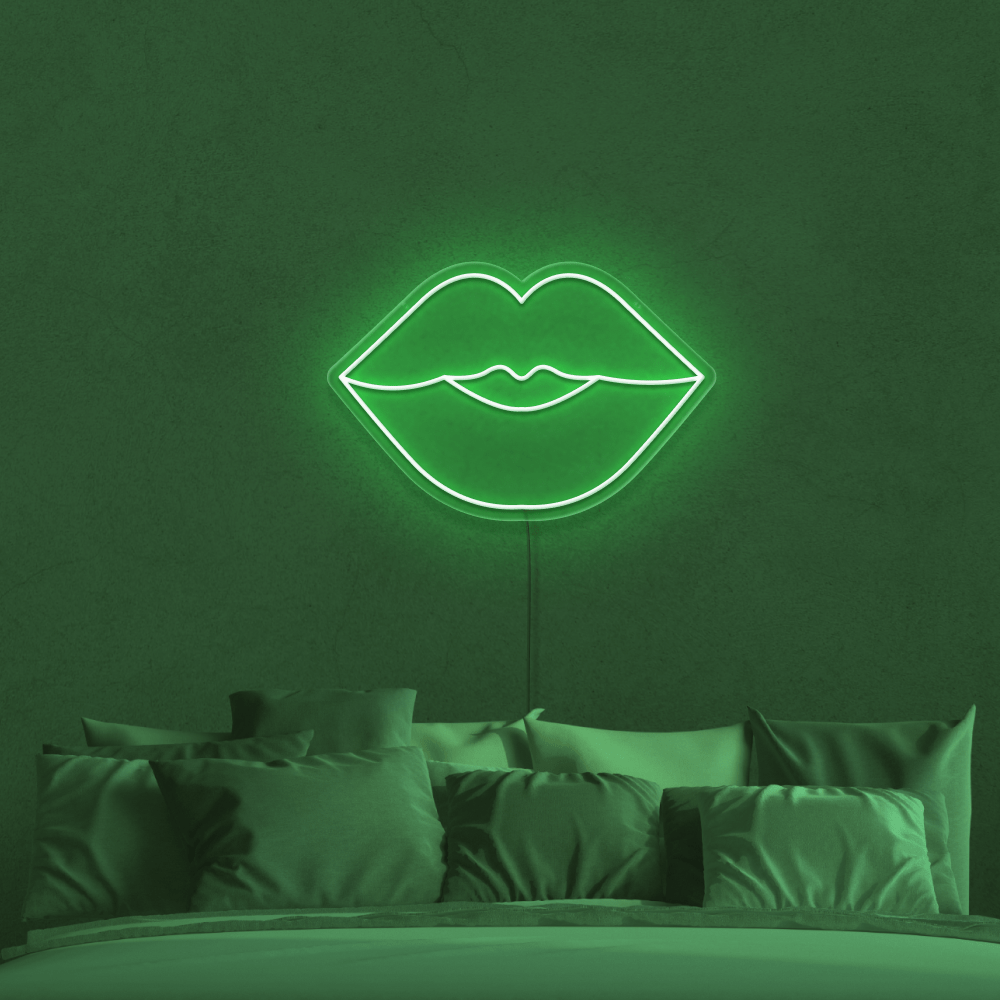 A bed with pillows and green neon light - Neon green, lips